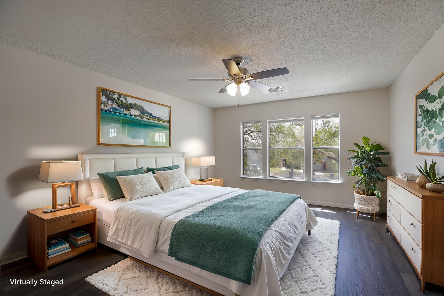 Bedroom featuring green bedding, wooden furniture, and nature-inspired wall art.