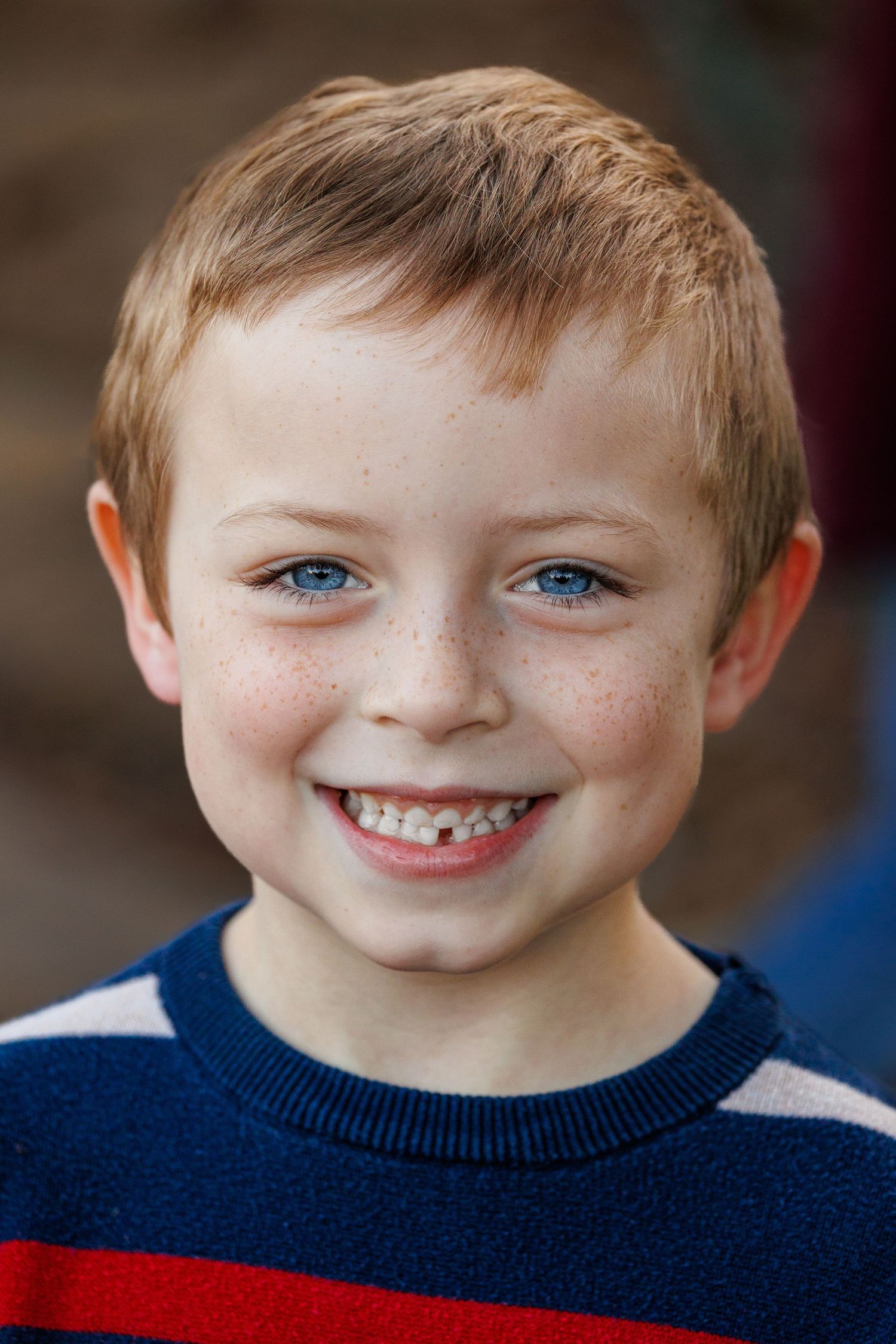Close-up portrait sequence showing joyful expressions in a navy sweater.