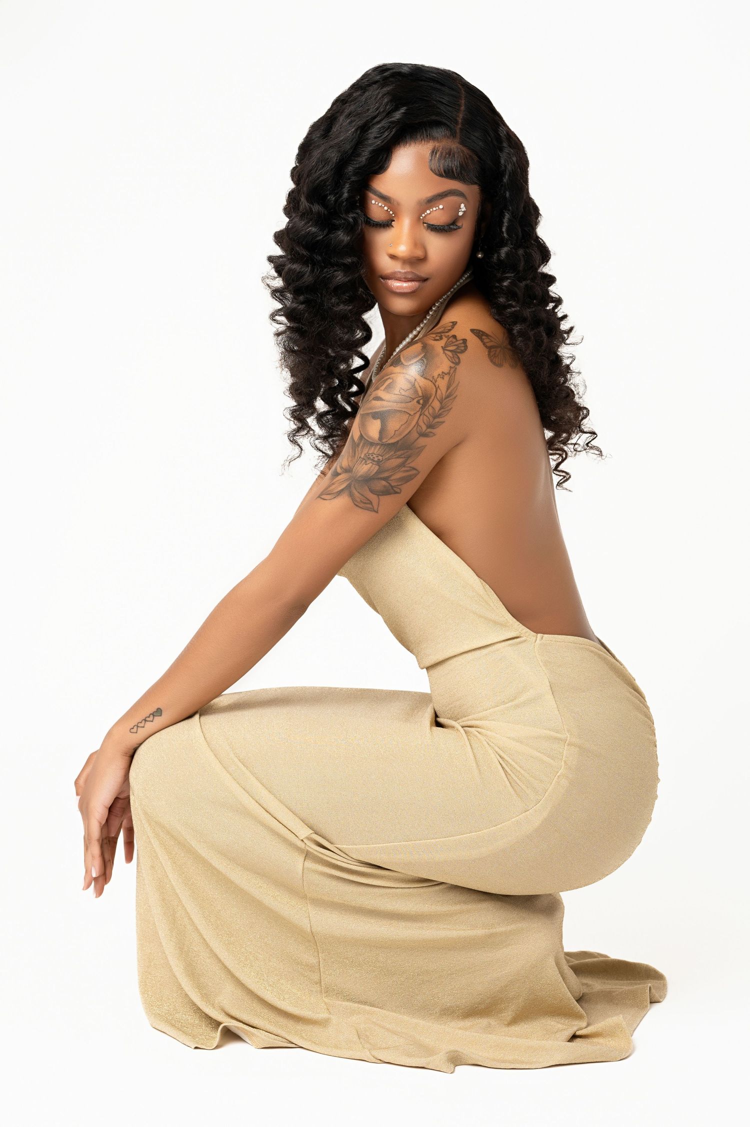 Elegant studio portraits in cream-colored dress against white background.