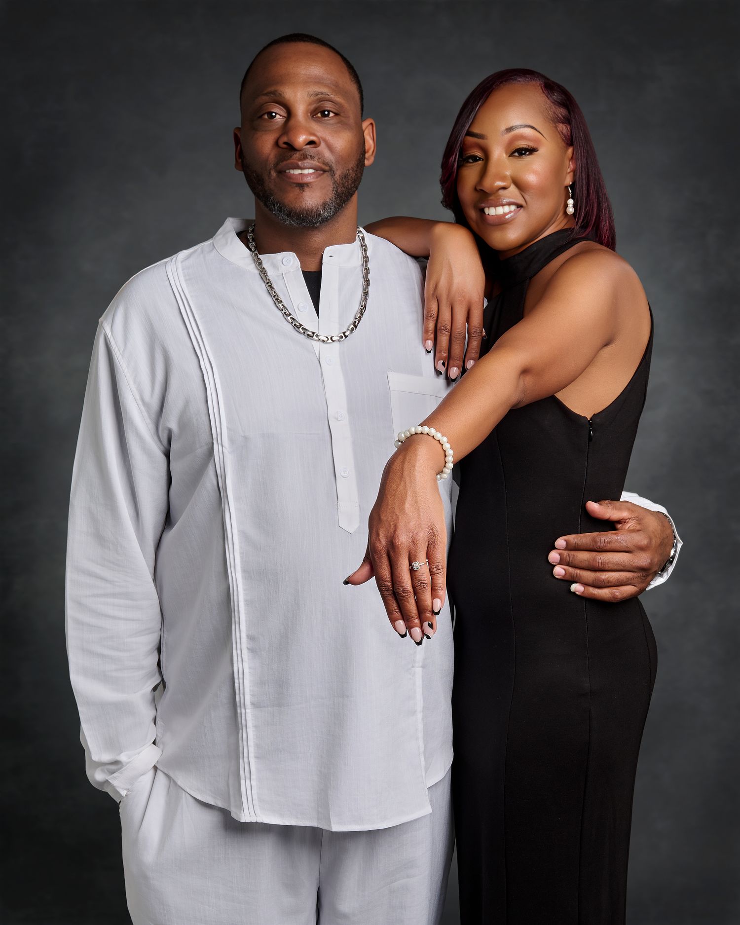 Studio photoshoot series showing couple in white and black outfits against dark background.
