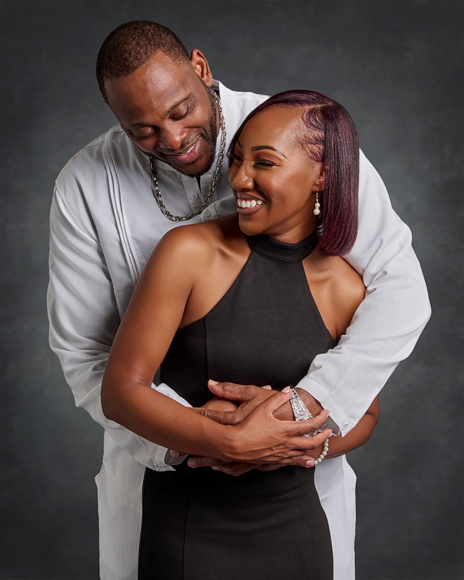 A couple shares a joyful embrace during their engagement photo session.