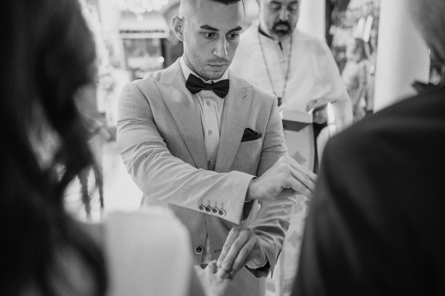 Black and white photo of formal wedding reception with elegant decor and lighting.