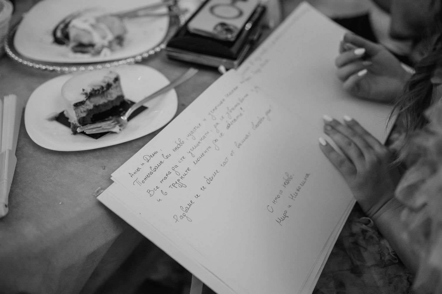 Close-up of wedding guestbook pages with handwritten messages and signatures.
