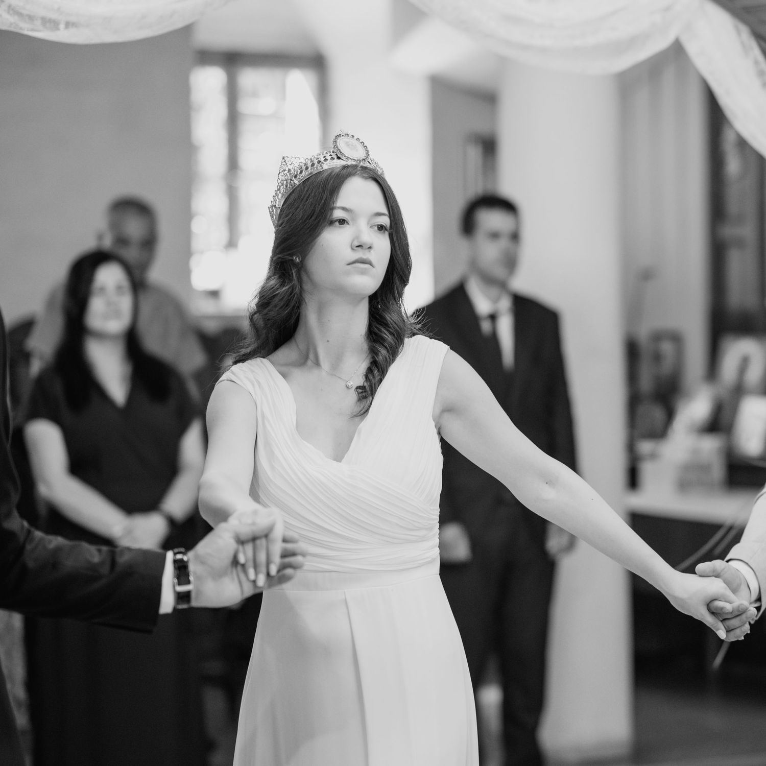 Wedding dance floor scene with flowing white dresses and formal attire.