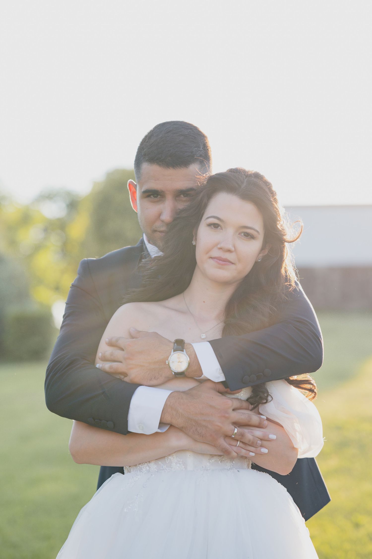 Romantic sunset wedding portraits in a serene outdoor setting.