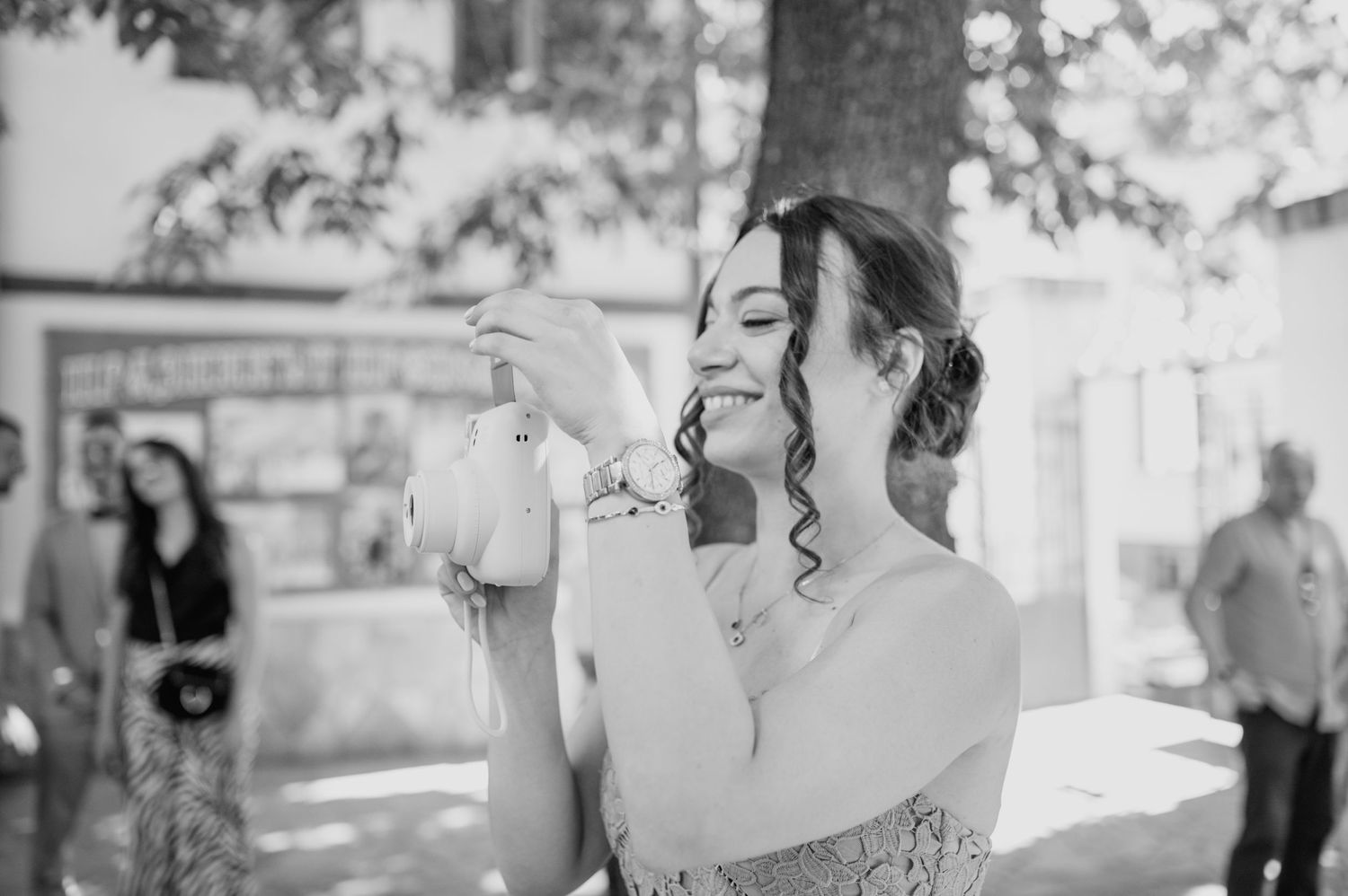 Black and white photo of a wedding couple sharing an intimate moment in a garden setting.