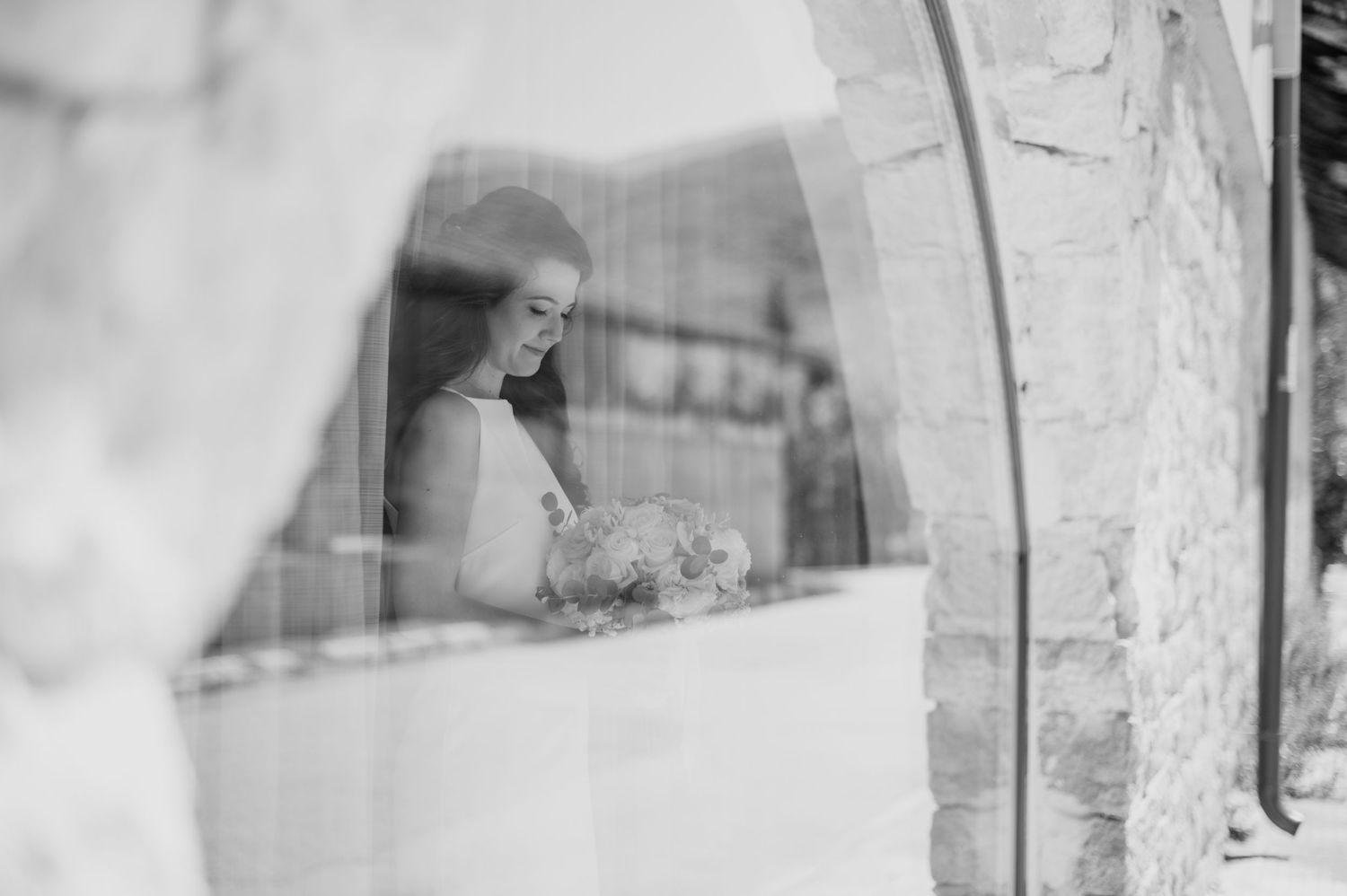 Atmospheric wedding preparation moments captured in soft window light.