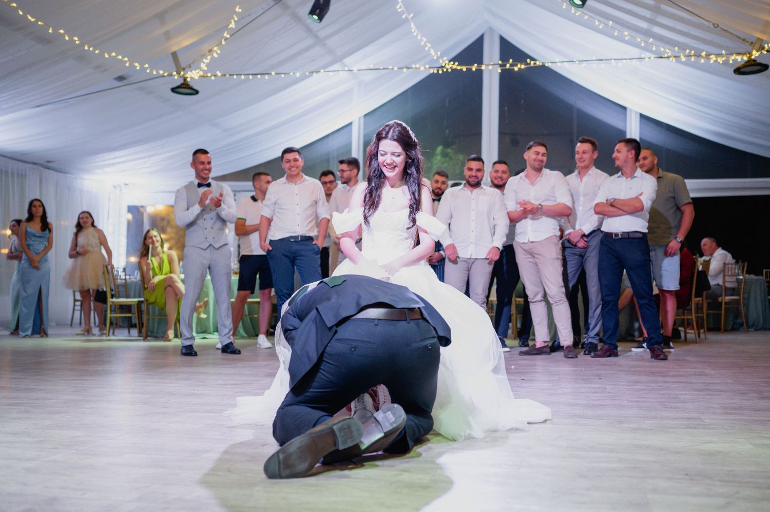 Wedding reception dance floor scene with guests watching a special dance moment.