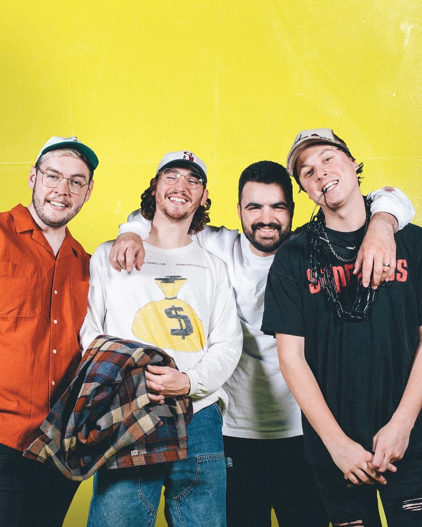 State Champs smiling and posing together against yellow background in casual wear.
