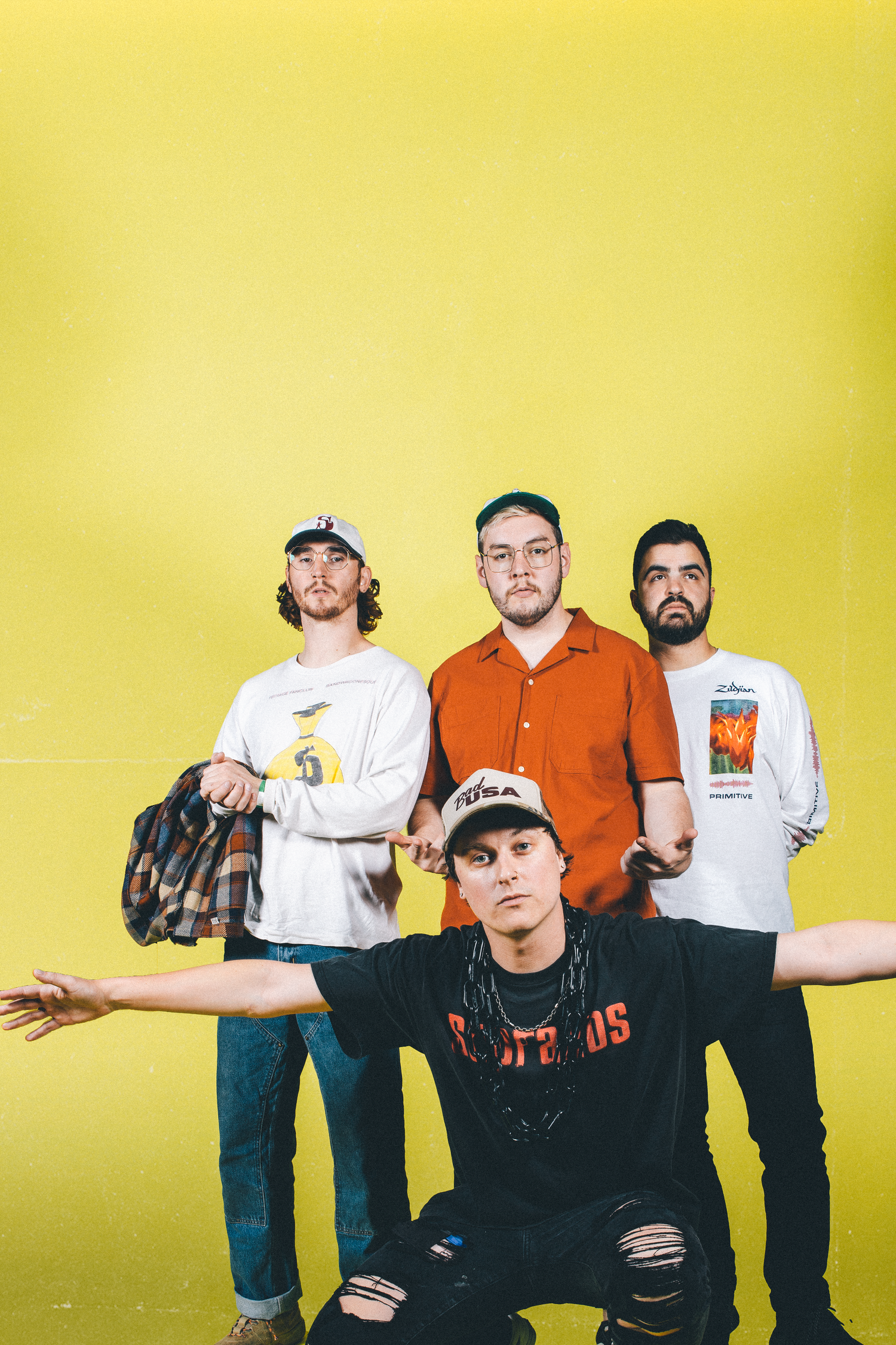 State Champs pose against yellow backdrop for promotional photo.