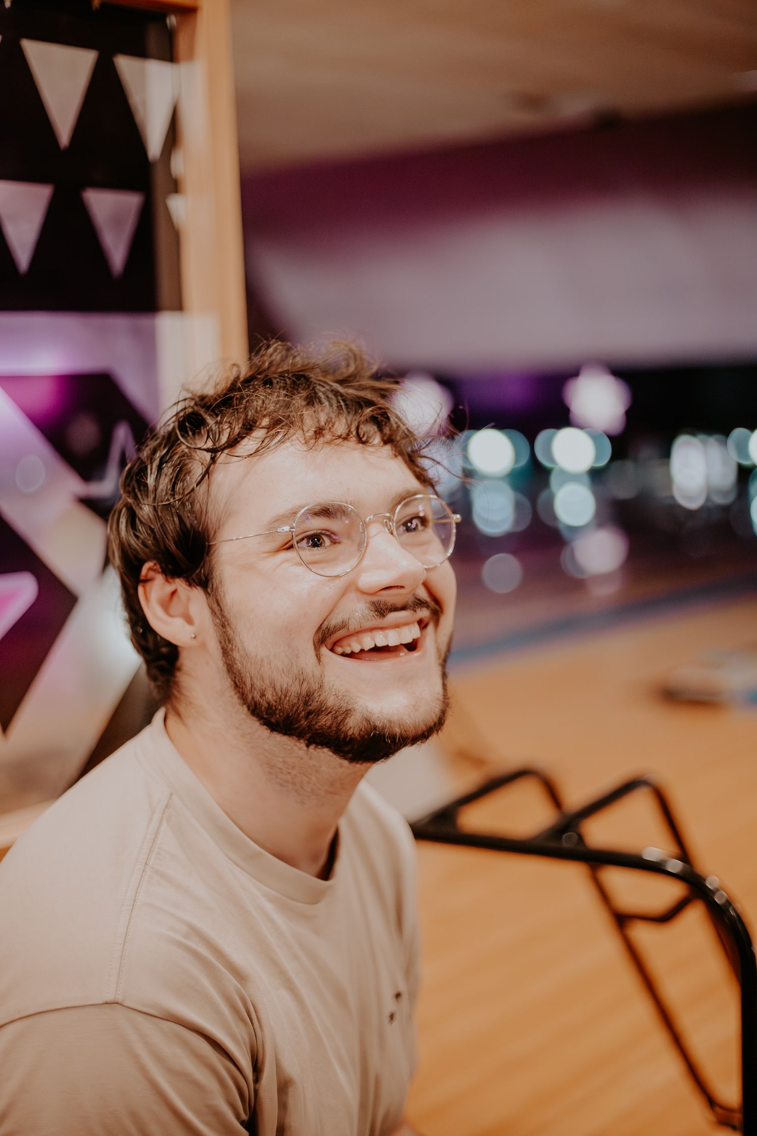 James Marriott with glasses smiling warmly in an indoor setting.