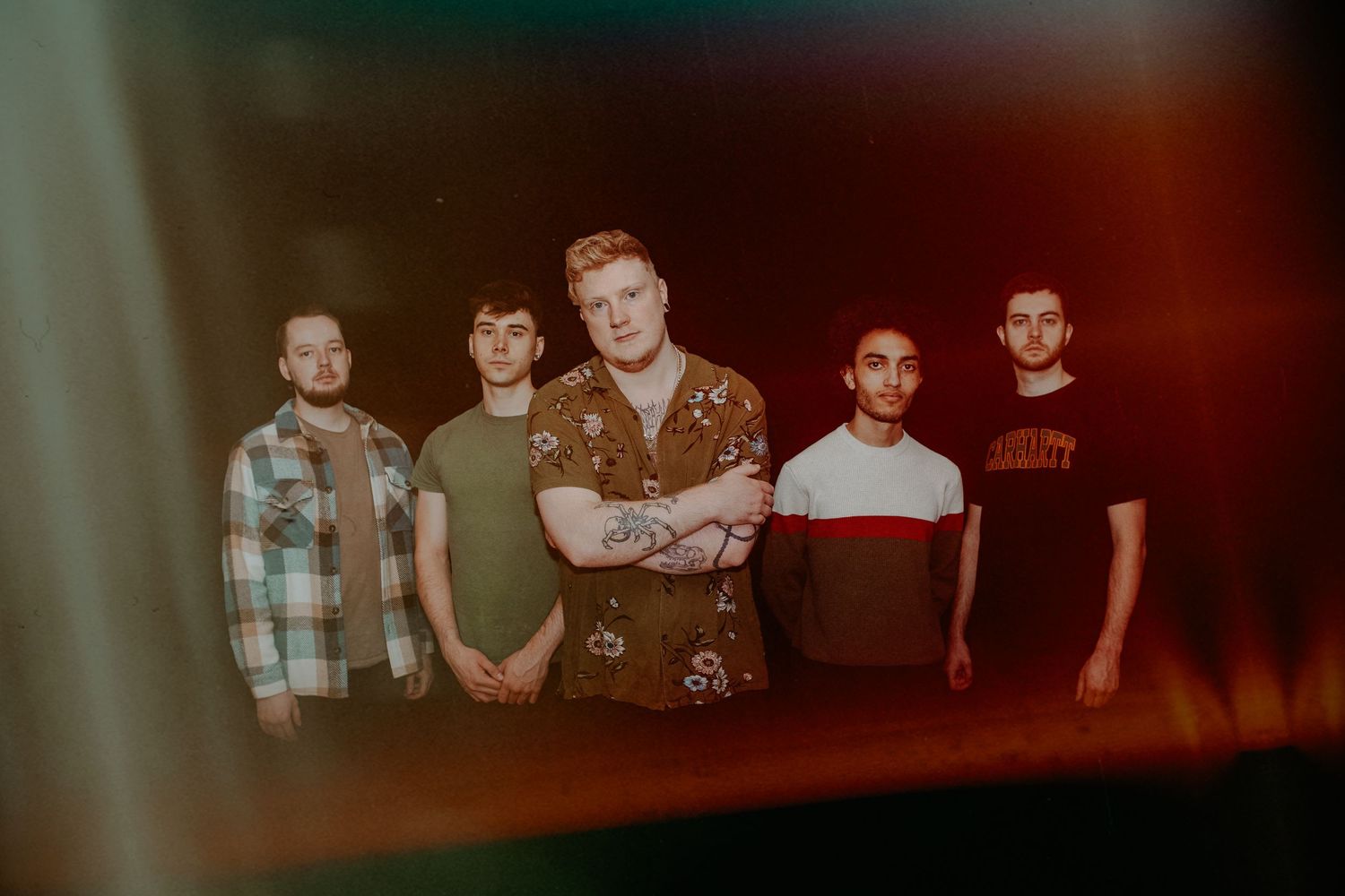 Dissonants poses for moody promotional photo with vintage color grading.