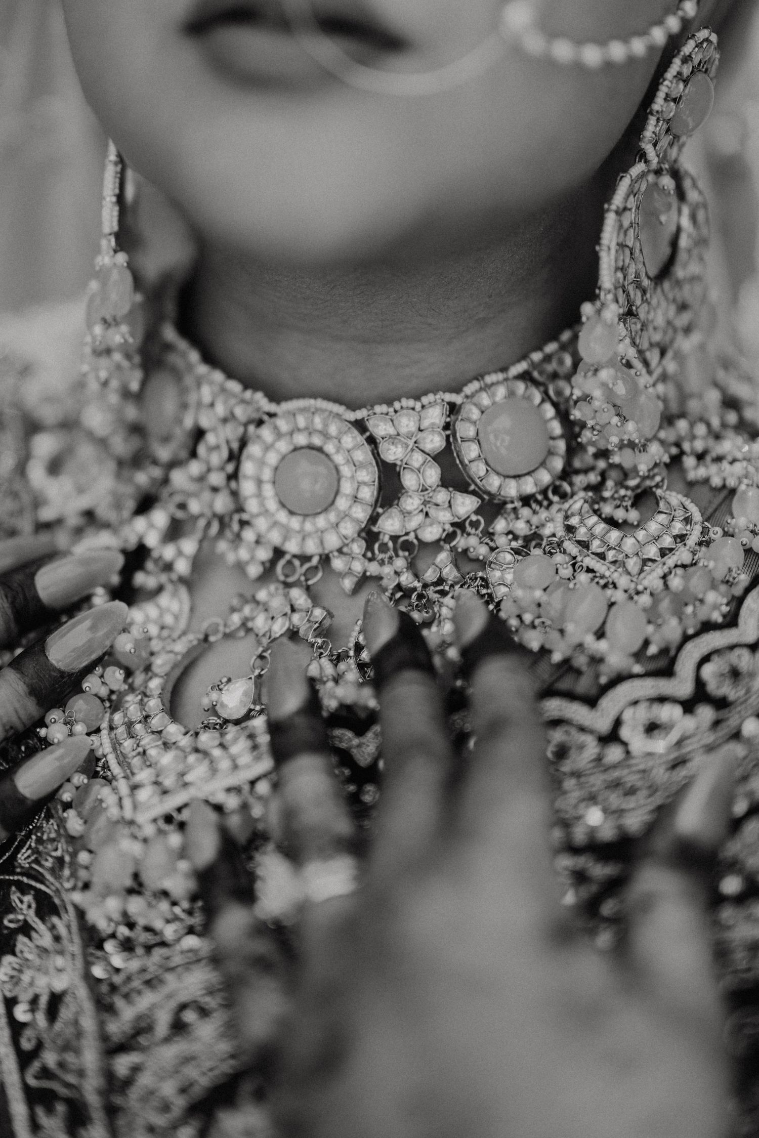 An elegant bridal jewelry display featuring ornate crystal necklaces and pearl accents in black and white.