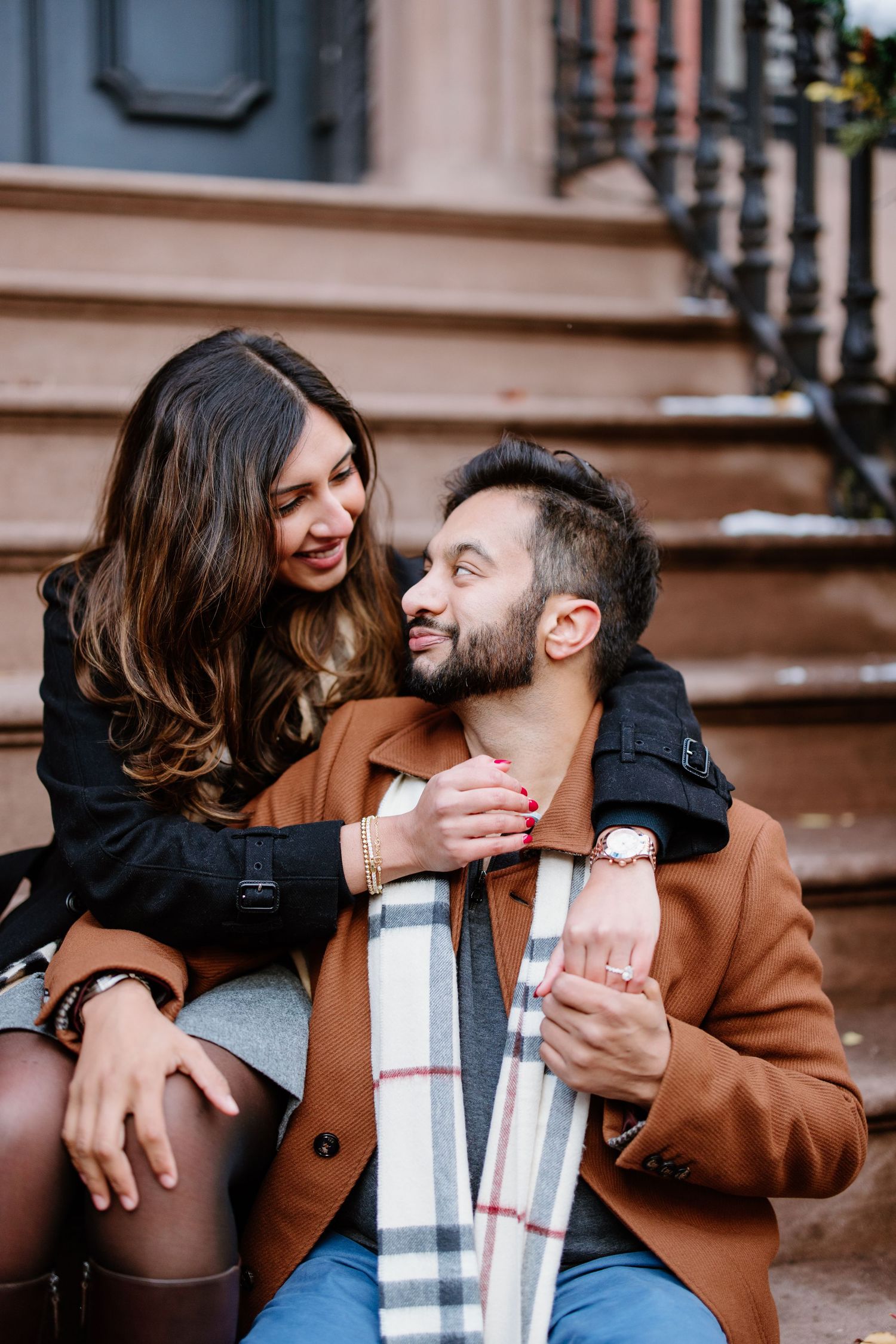 A romantic couple sits together on steps sharing intimate moments in six sequential frames.