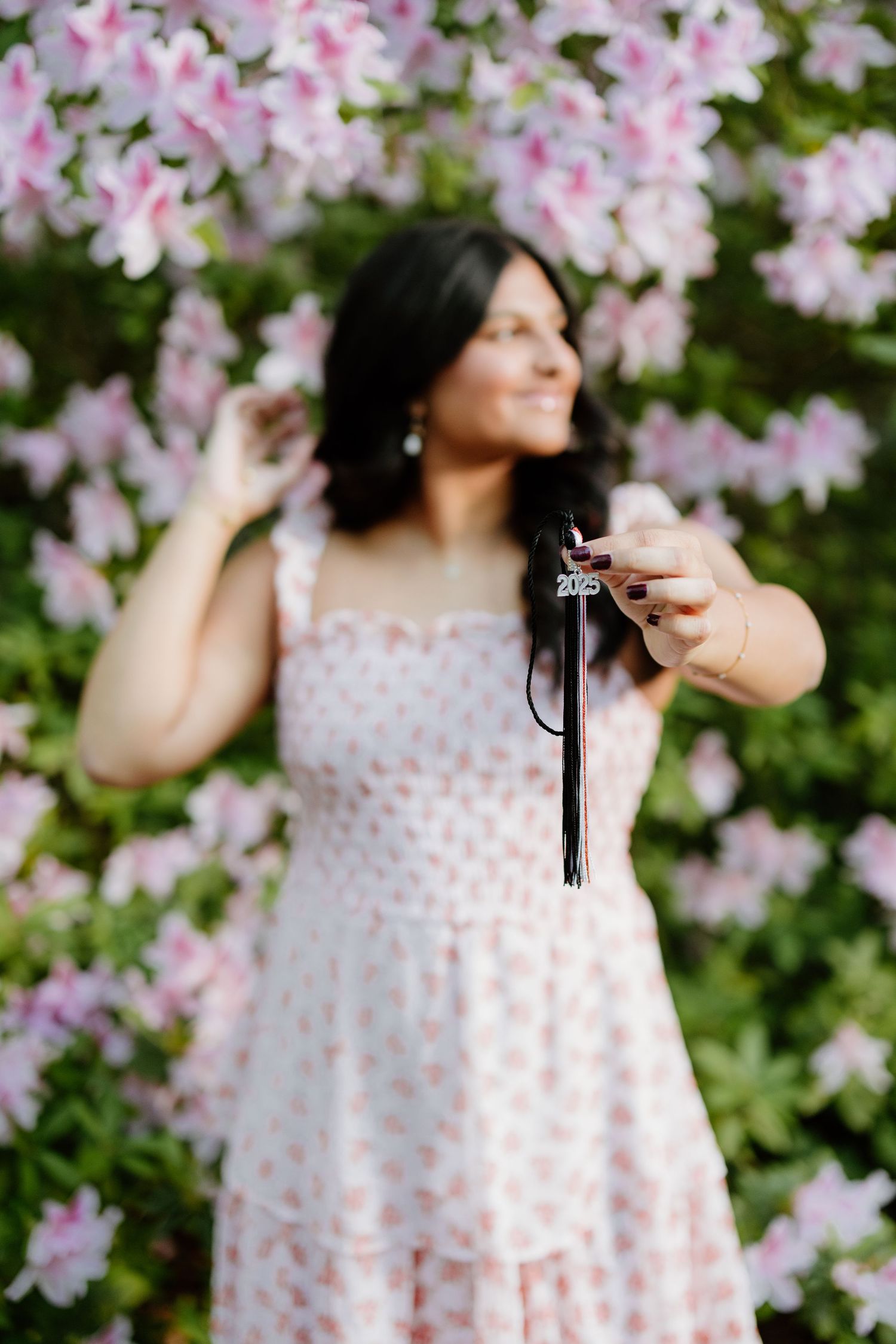 A sequence of ethereal spring photos showing delicate pink cherry blossoms framing a flowy polka dot dress against lush foliage.
