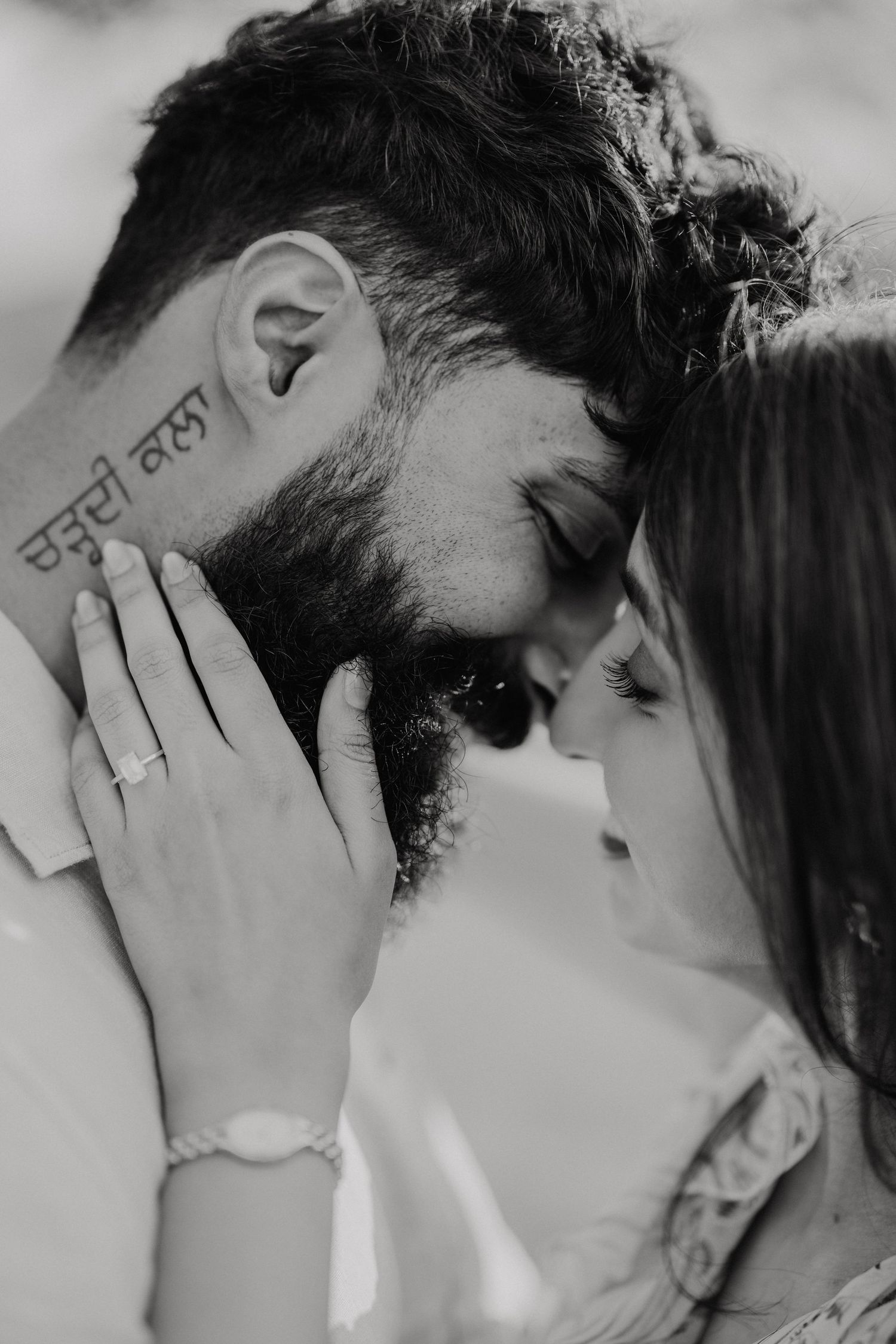 Four black and white images showing a romantic kiss between two people.