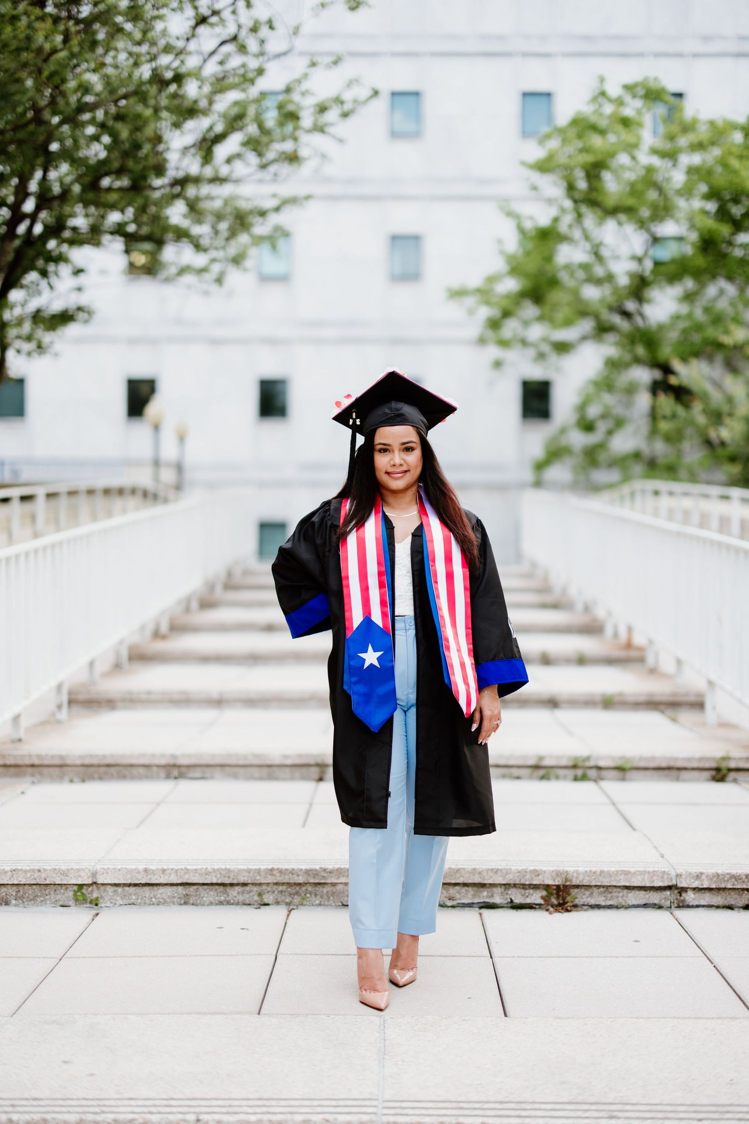 A collage of graduation photos showing a graduate in traditional black cap and gown against a white stone backdrop.