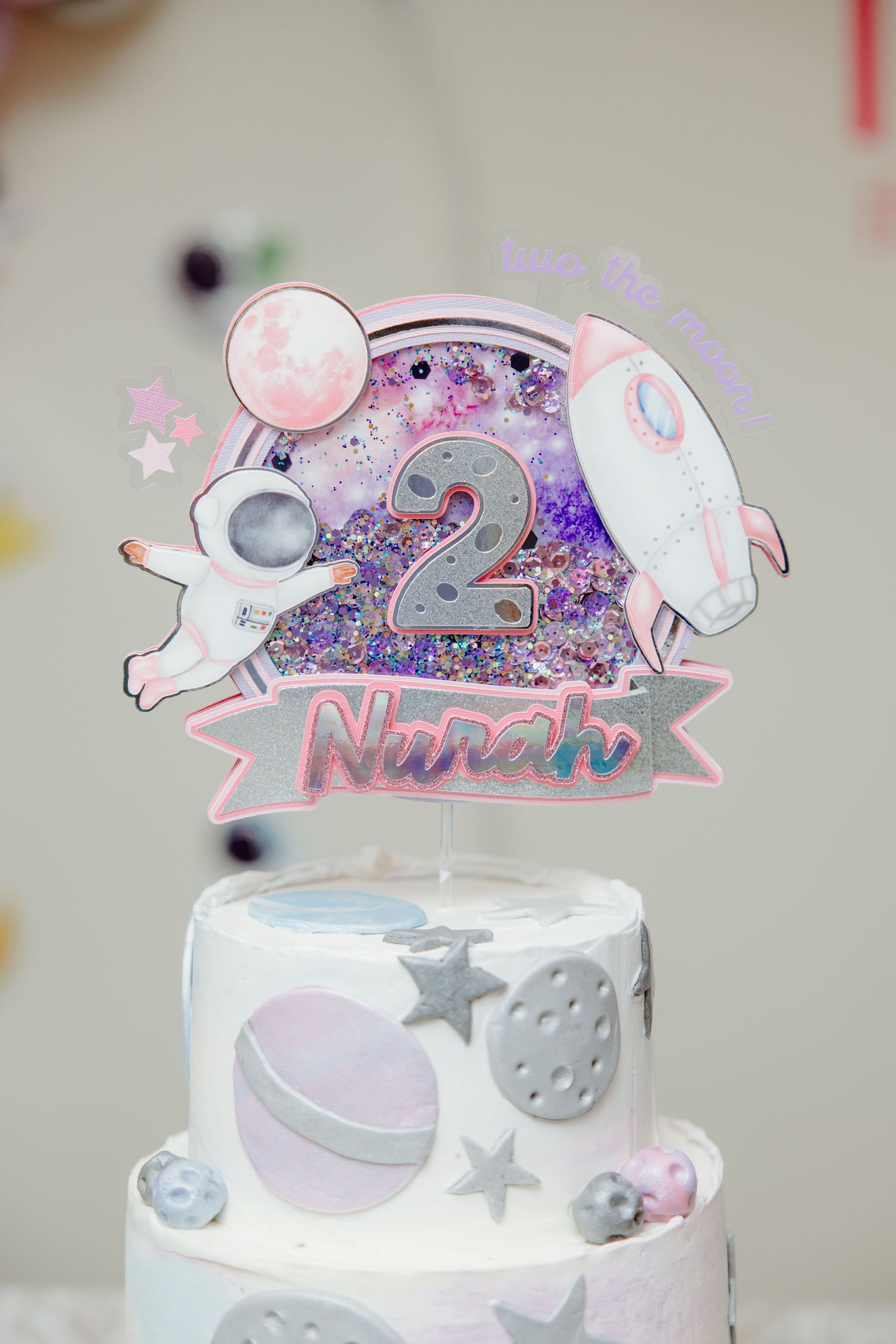 Cute elephant cake topper design with pink and gray colors featuring stars and sparkly details against a white background.