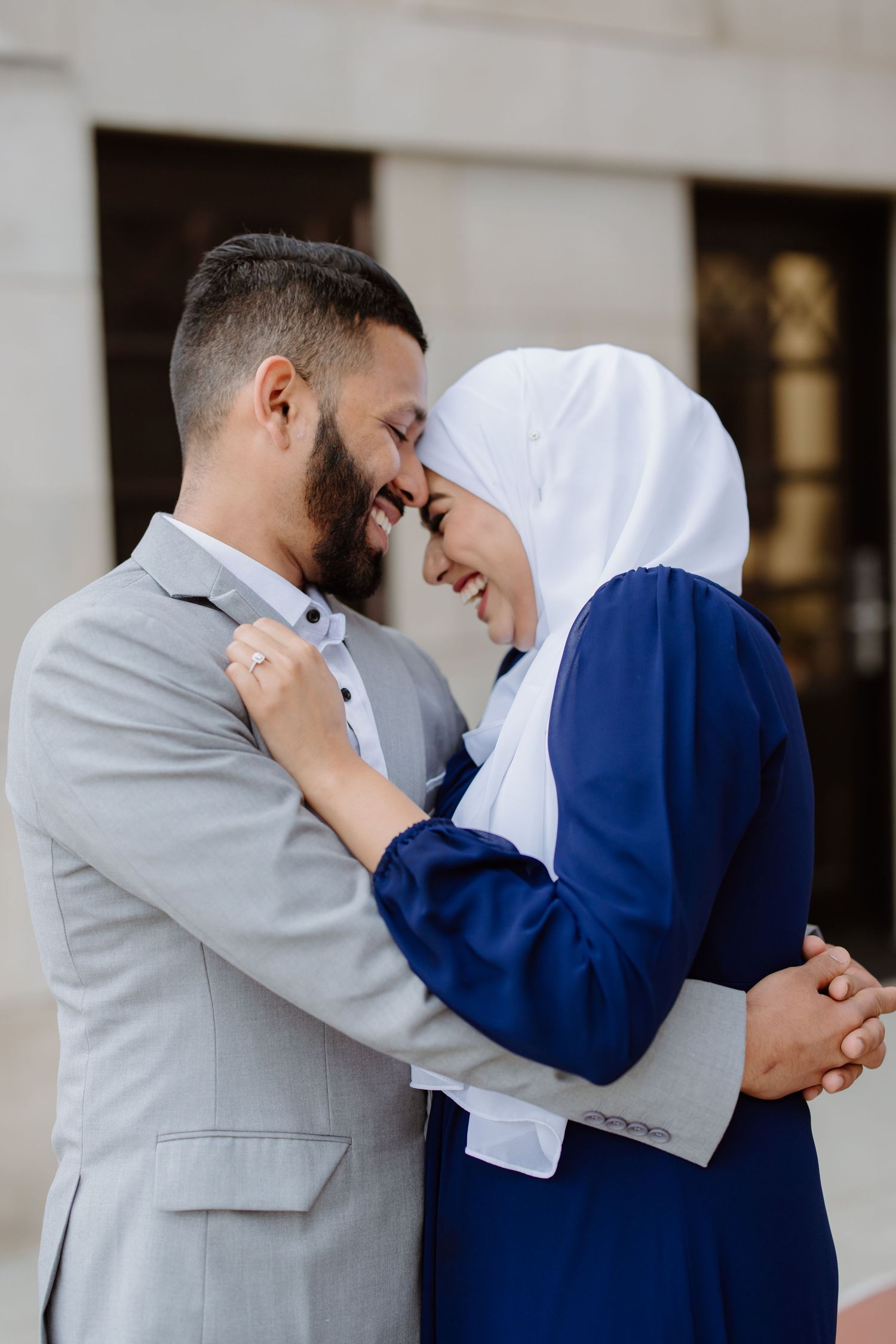 A couple shares intimate moments in a progressive sequence showing them leaning in close in complementary gray and blue outfits.