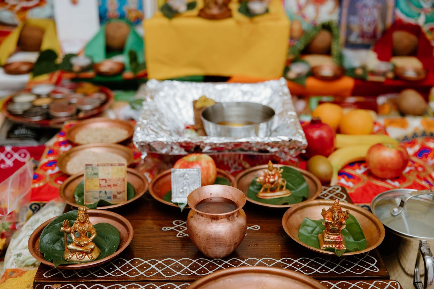 Traditional Mexican fiesta table setting with green plates, rustic pottery, and decorative serving dishes laid out for a celebration.
