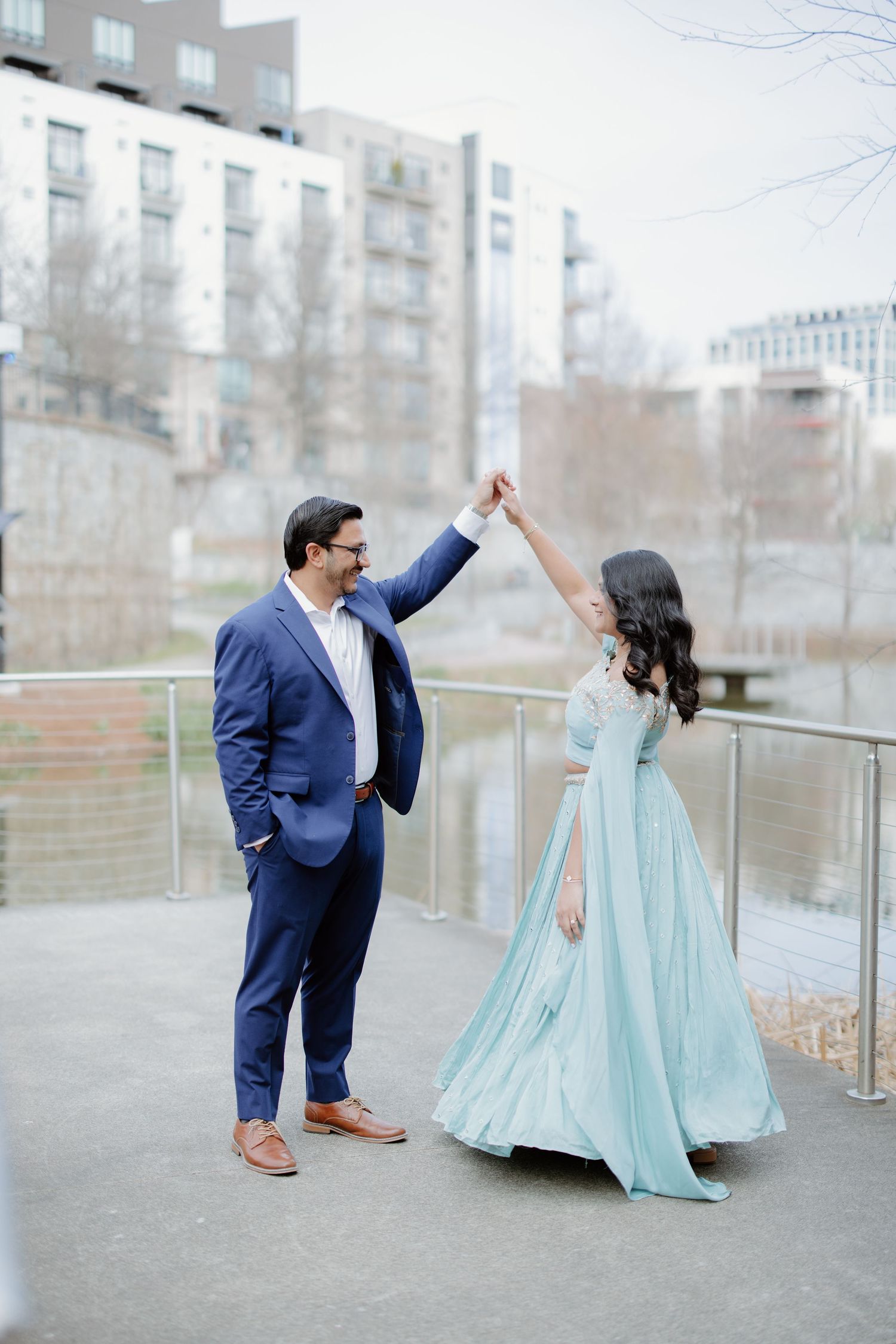 Couple in formal attire - navy suit and mint gown - posing playfully in a series of romantic photos outdoors.