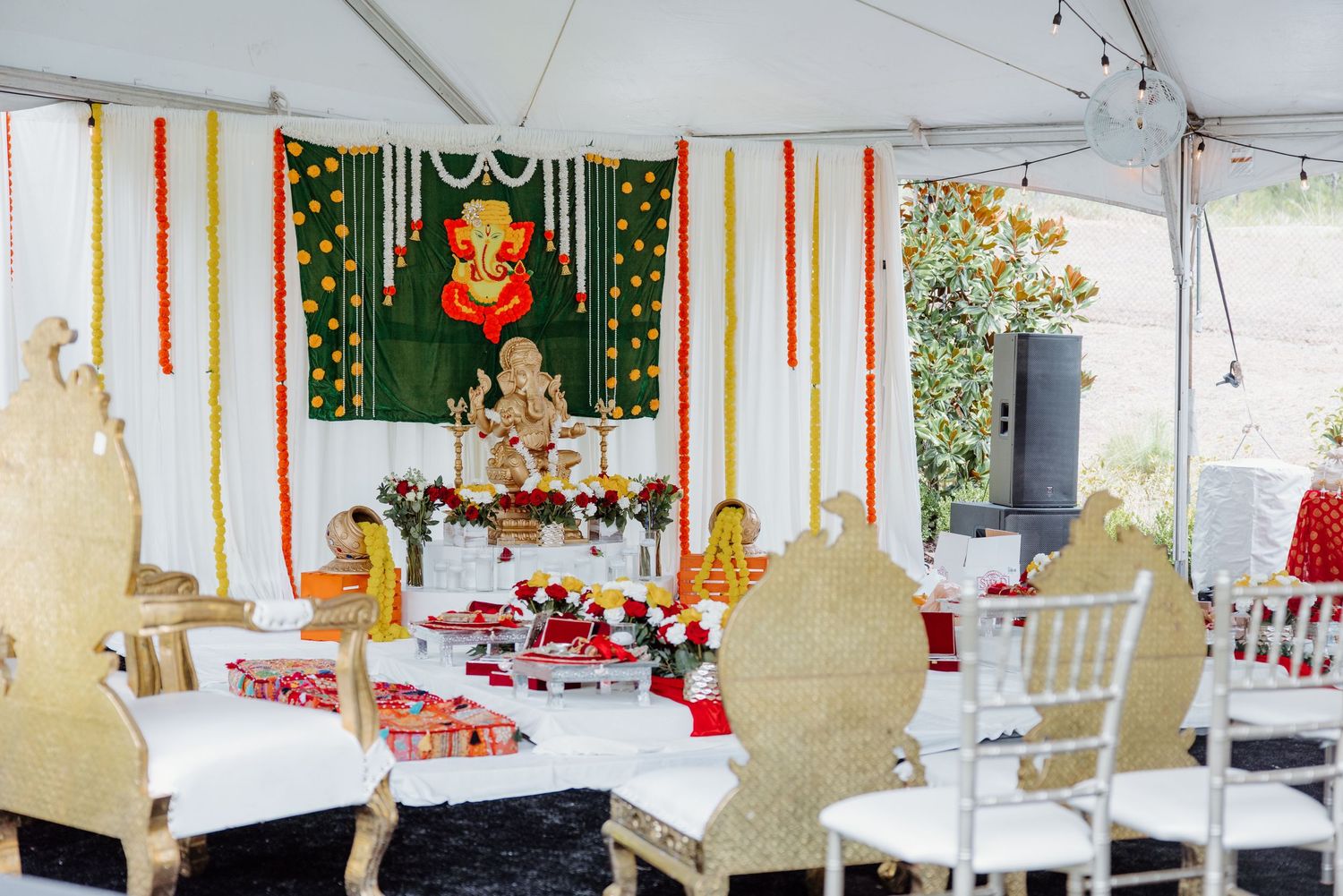 White event tent decorated with colorful streamers and banners for an outdoor celebration or gathering.