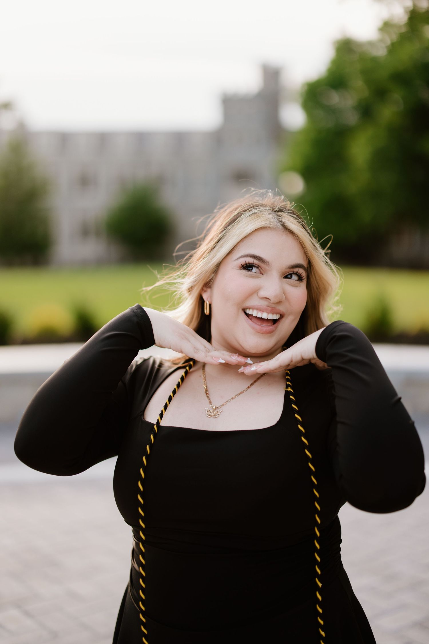 A person wearing a black top poses playfully in a series of candid shots outdoors on an overcast day.