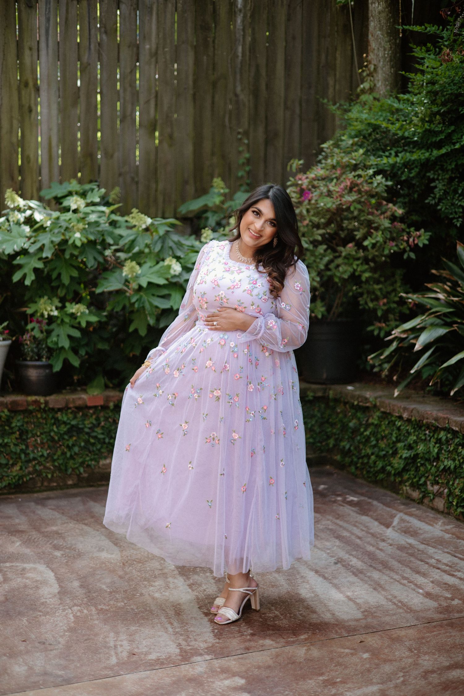 A series of four photos showing pink tulle dress details against a wooden deck in a garden setting.