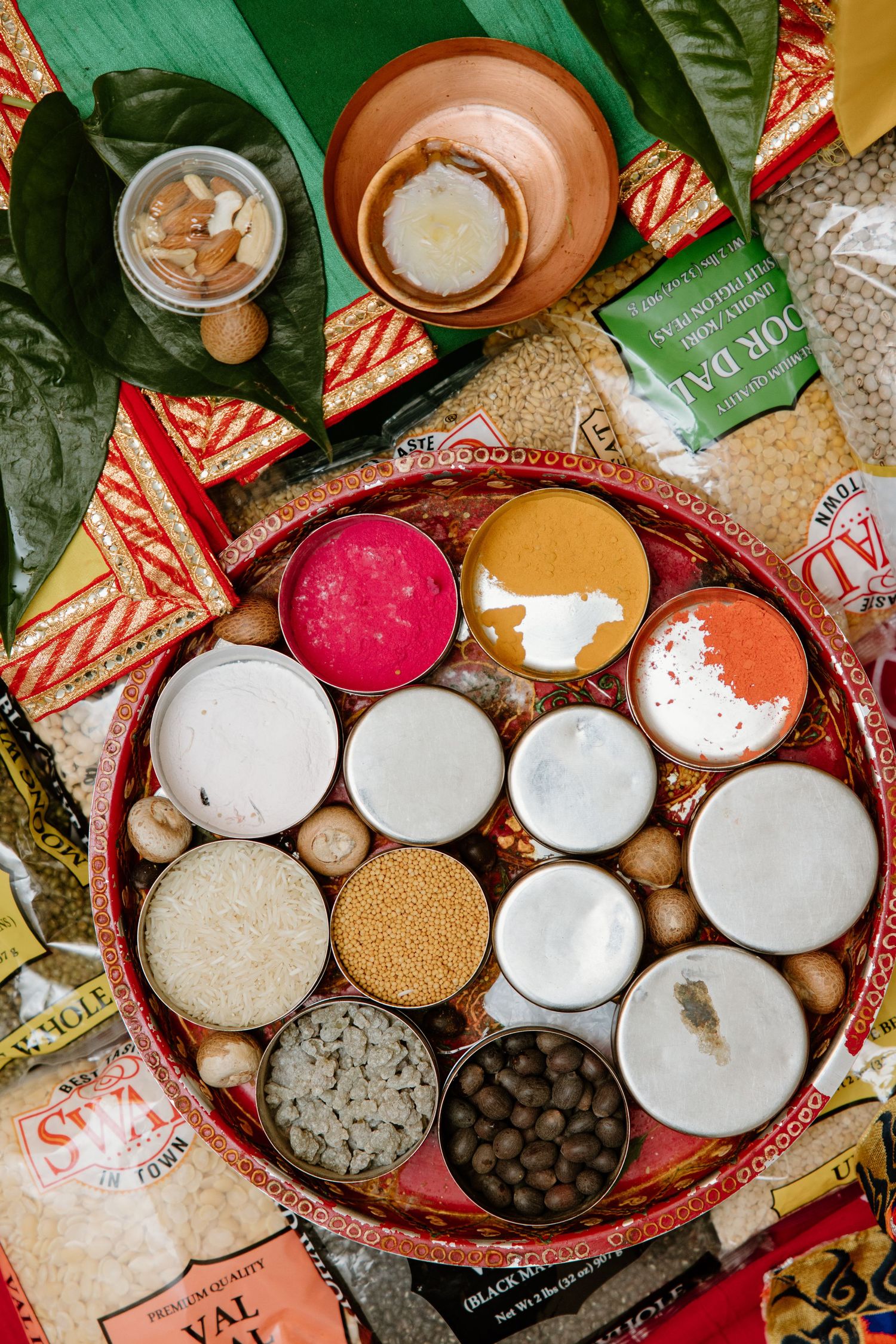 Various Vietnamese coffee preparation ingredients with traditional condensed milk and coffee grounds arranged in rustic bowls.