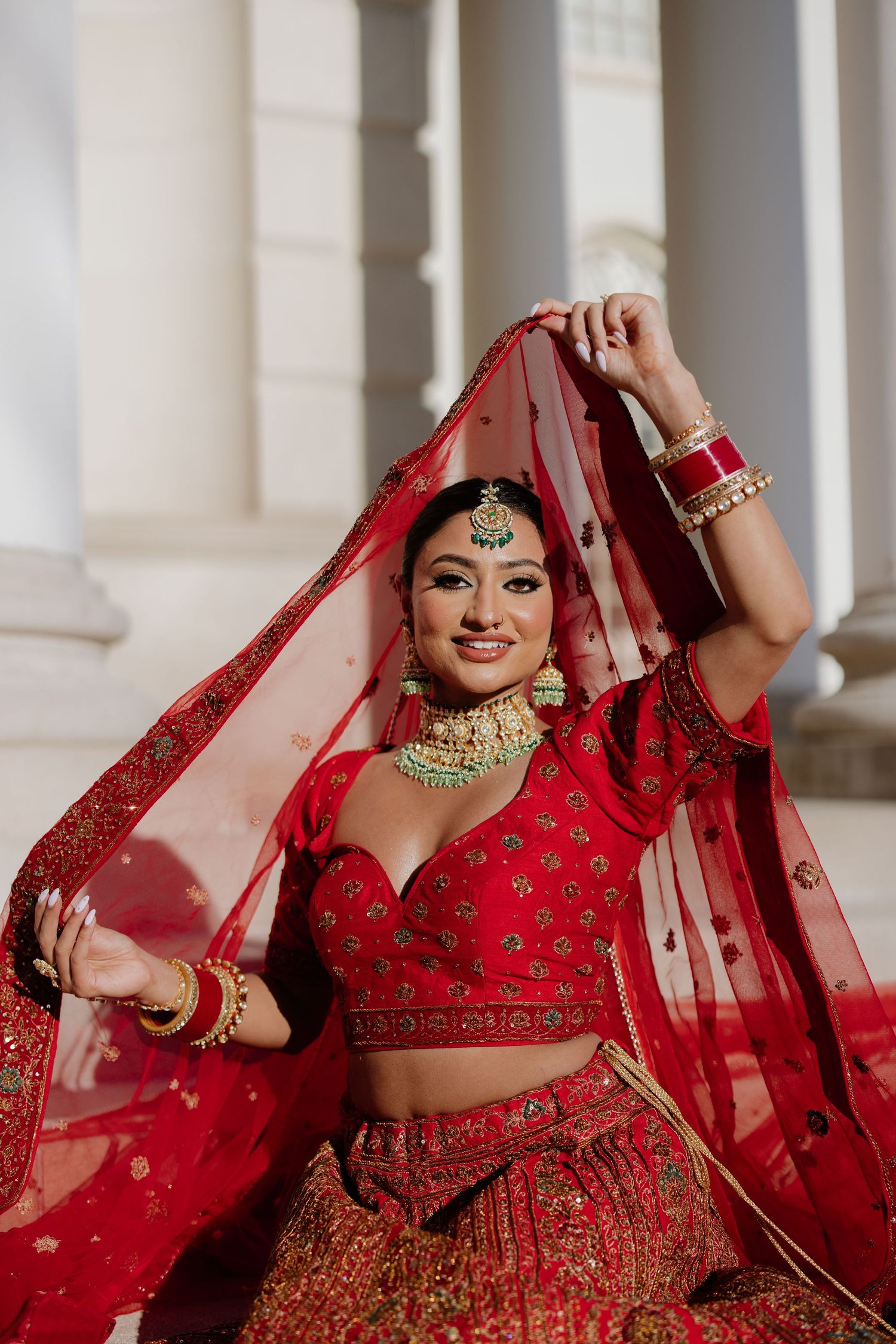 Four sequential photos show a bride in a traditional red Indian lehenga and jewelry posing gracefully with her dupatta.