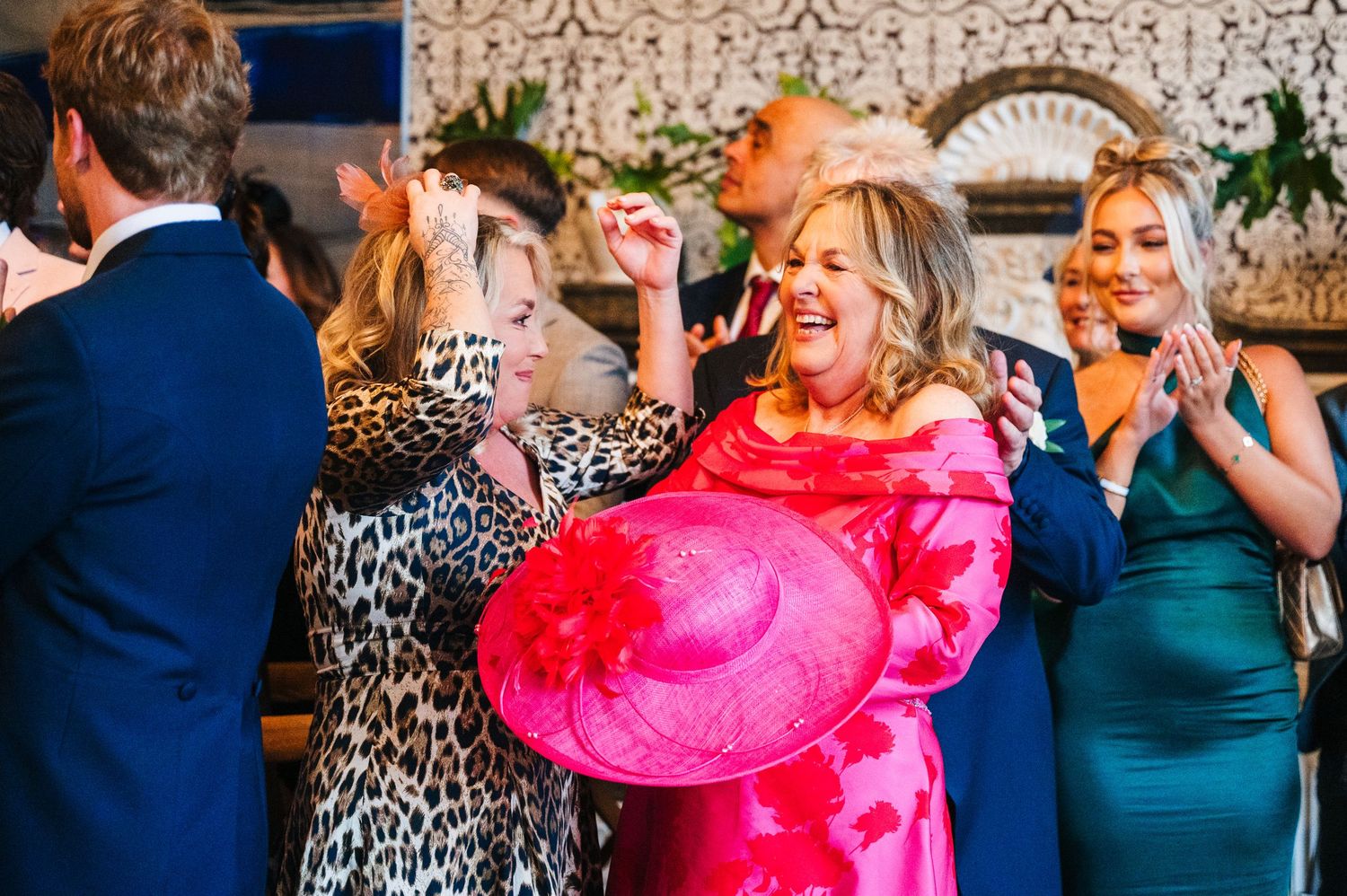 Wedding guests laugh and celebrate during a lively reception with festive lighting and decor.  Virginia Park Lodge Wedding Photographer Cava