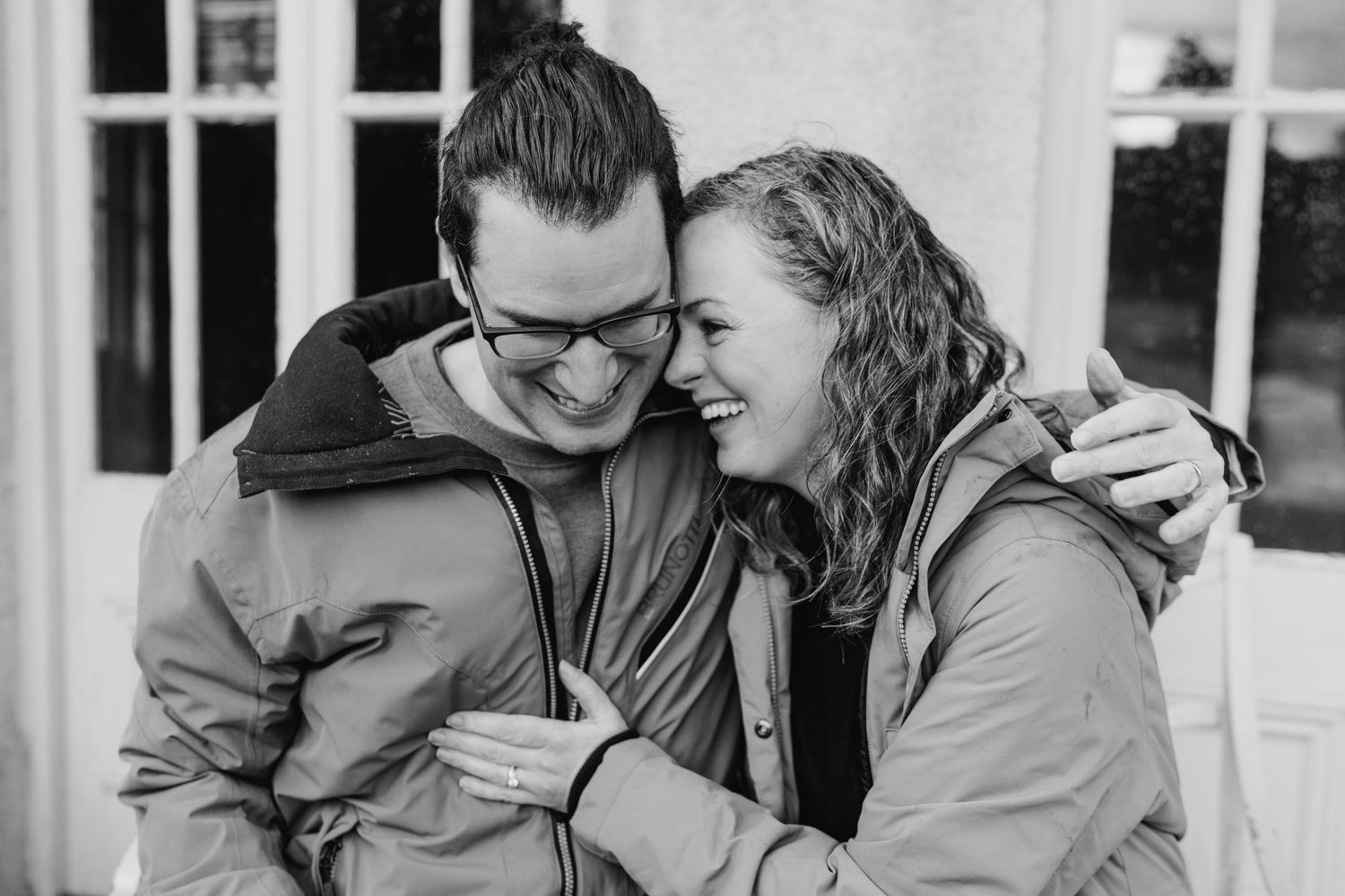A couple enjoys an intimate moment together while sitting at a dining table by a window. PHOTOGRAPHER Dublin ireland