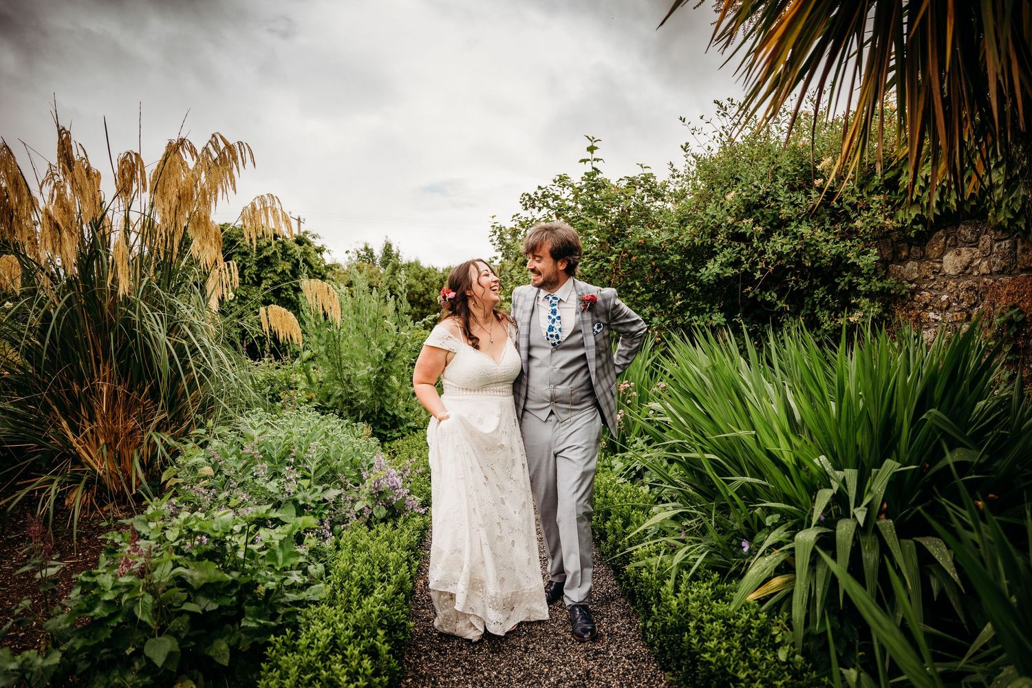 Garden wedding venue with tropical plants and palm trees under cloudy skies. Wedding photographer Dublin