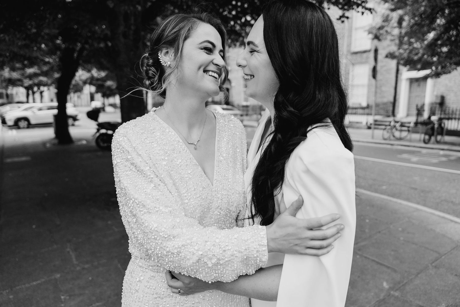 Two people in wedding attire sharing an intimate embrace outdoors in black and white photography. House Dublin Wedding Photographer