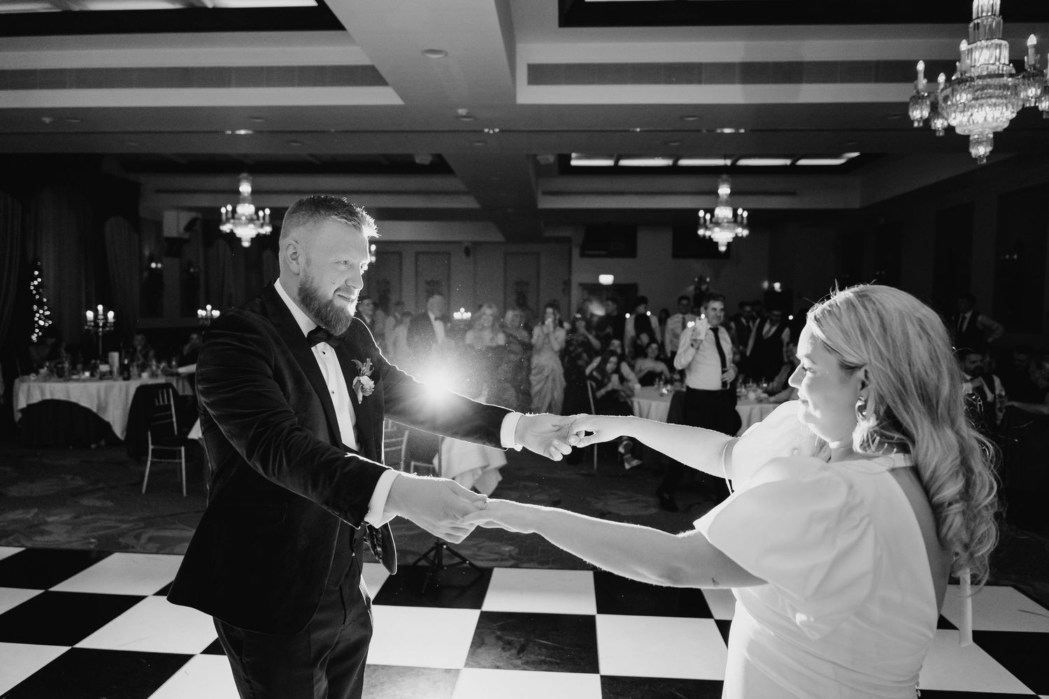 Wedding reception dance captured in dramatic black and white with checkerboard floor. City Hall Dublin Photographer
