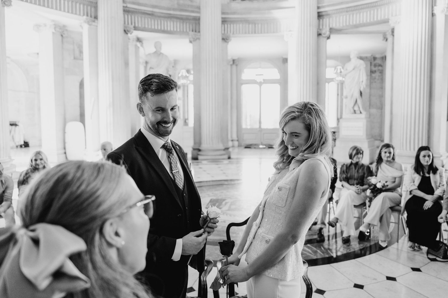 Elegant interior of a grand hall with white columns and ornate architectural details. City Hall Dublin wedding photogrAPher