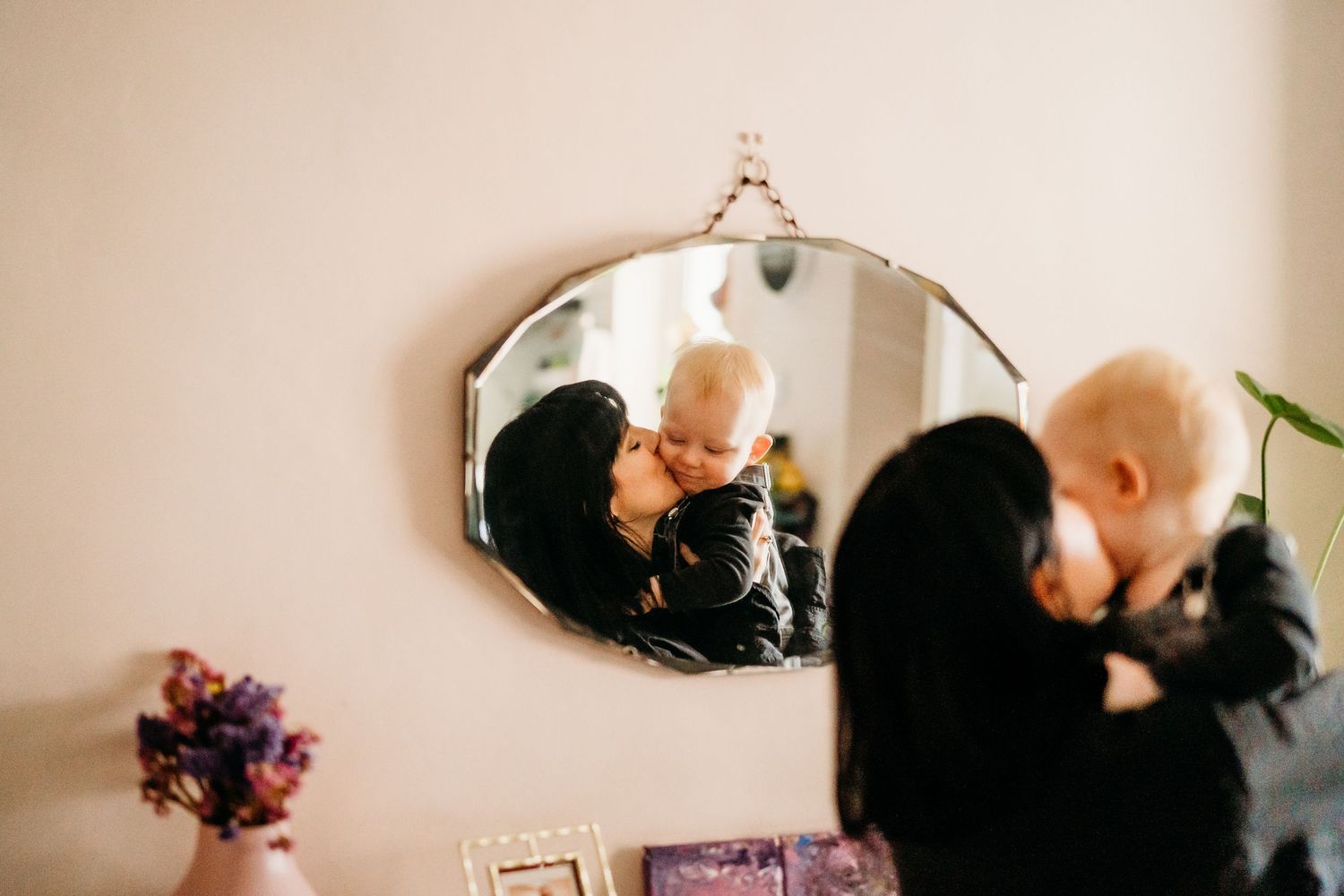 Series of artistic black and white lifestyle portraits showing tender interactions near a window.  Family PHOTOGRAPHER Dublin