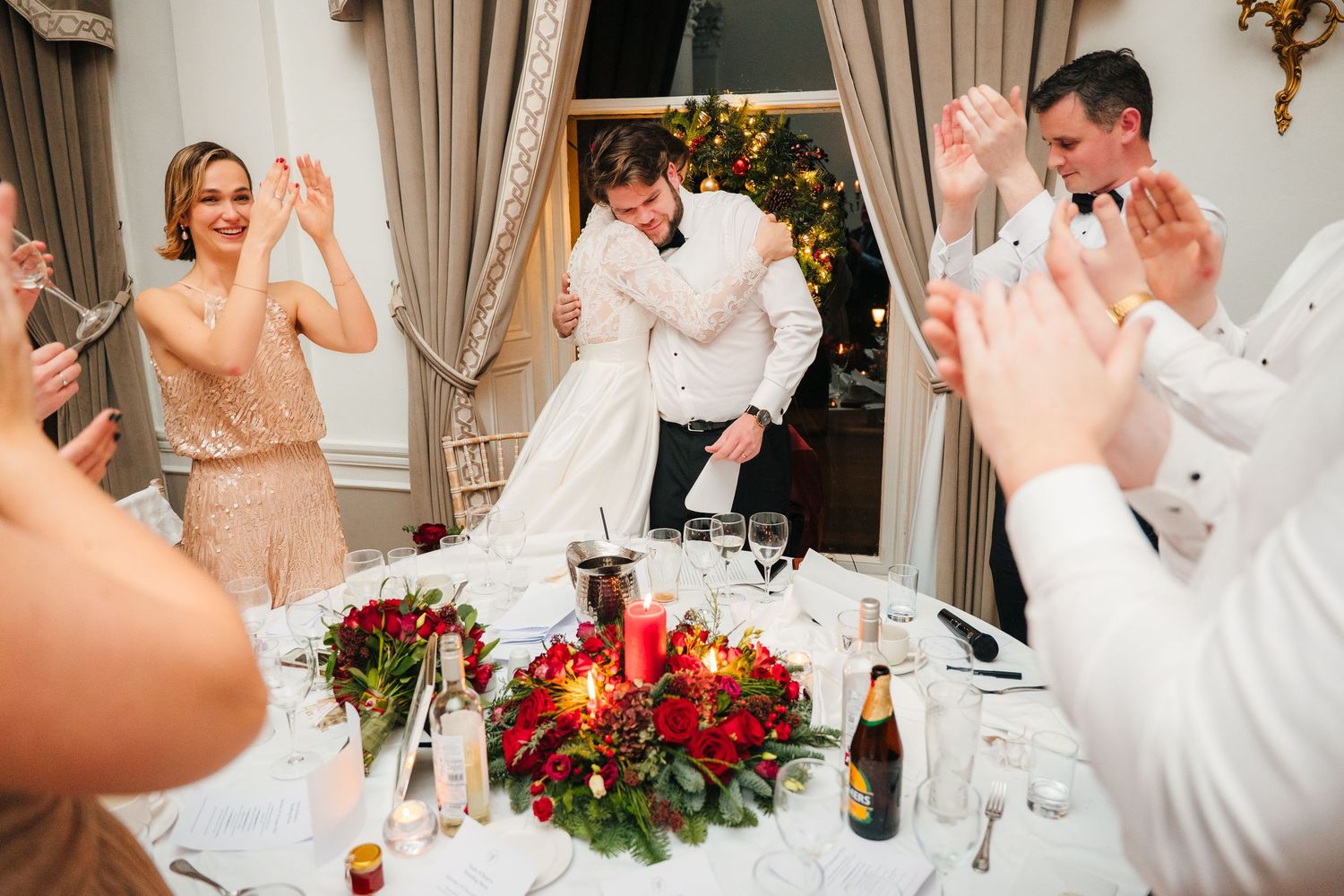 Wedding reception guests raise their glasses in a toast at an elegant dinner table. Stephens green club dublin Wedding photographer