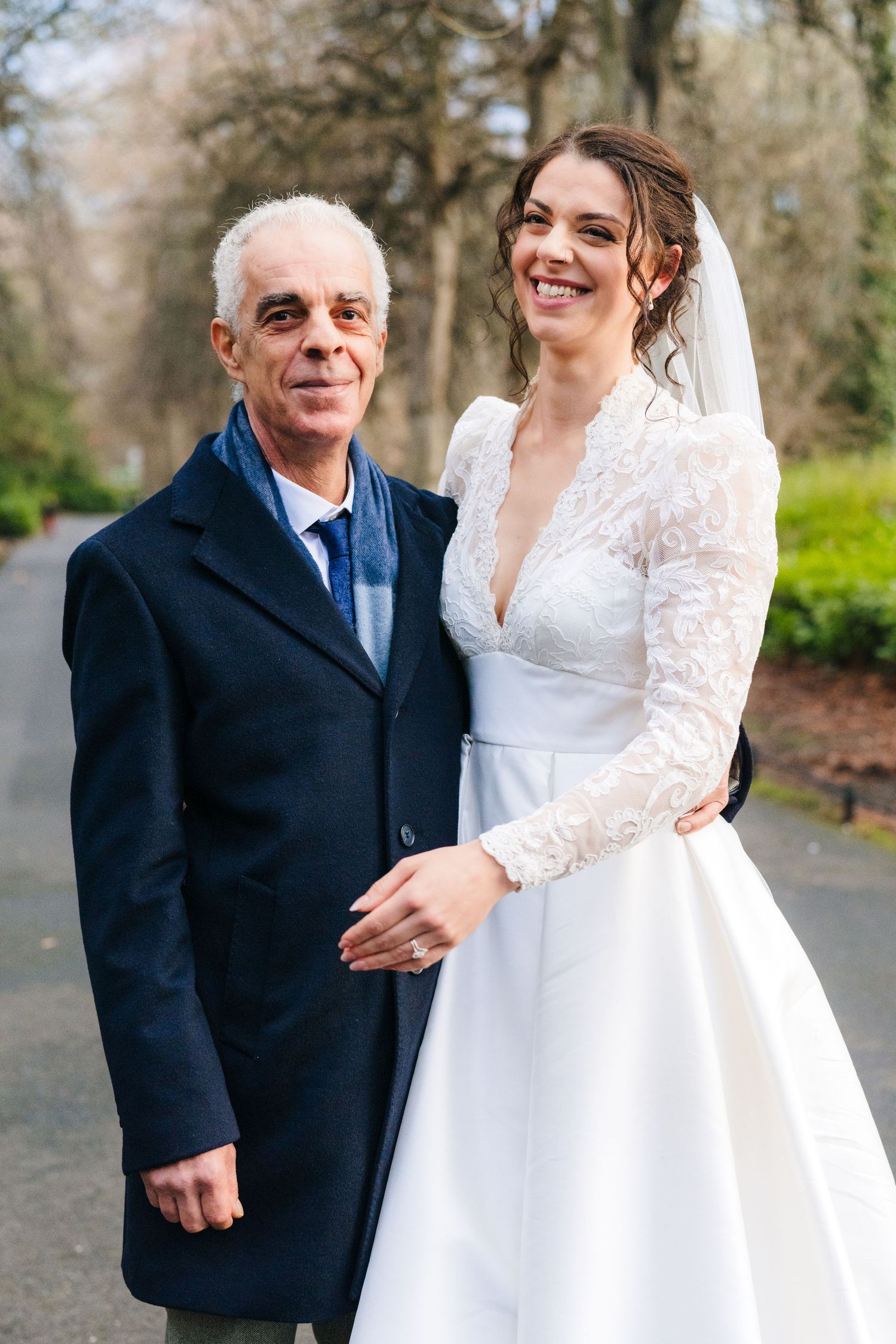 Wedding photos on a tree-lined path showing sweet moments between bride and companion. Stephens green club dublin Wedding photographer