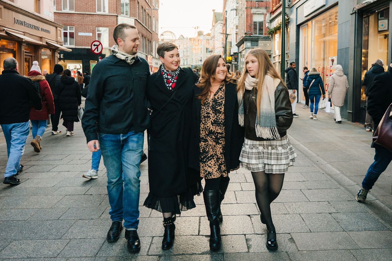 Busy shopping street in Dublin with pedestrians and historic storefronts. amily PHOTOGRAPHER Dublin