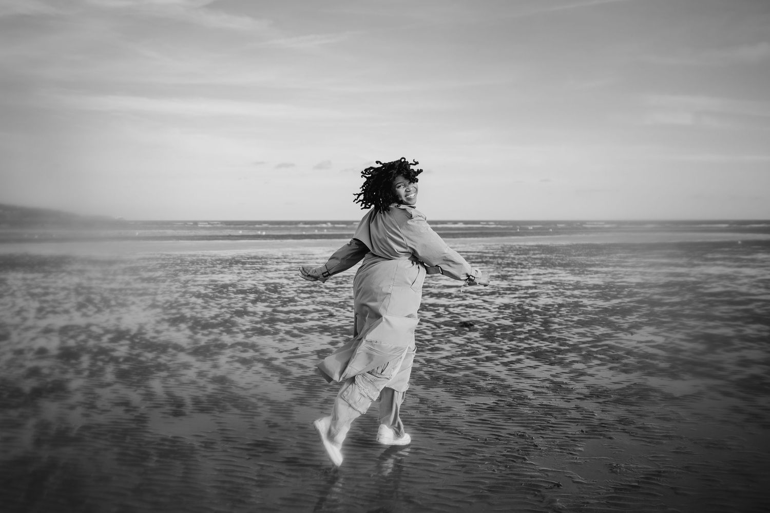 Black and white artistic photo of someone twirling in an open landscape. Dublin professional headshots photographer