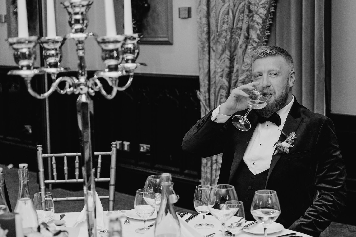Reception guests enjoying dinner and conversation at elegant indoor venue. Wedding photographer dublin