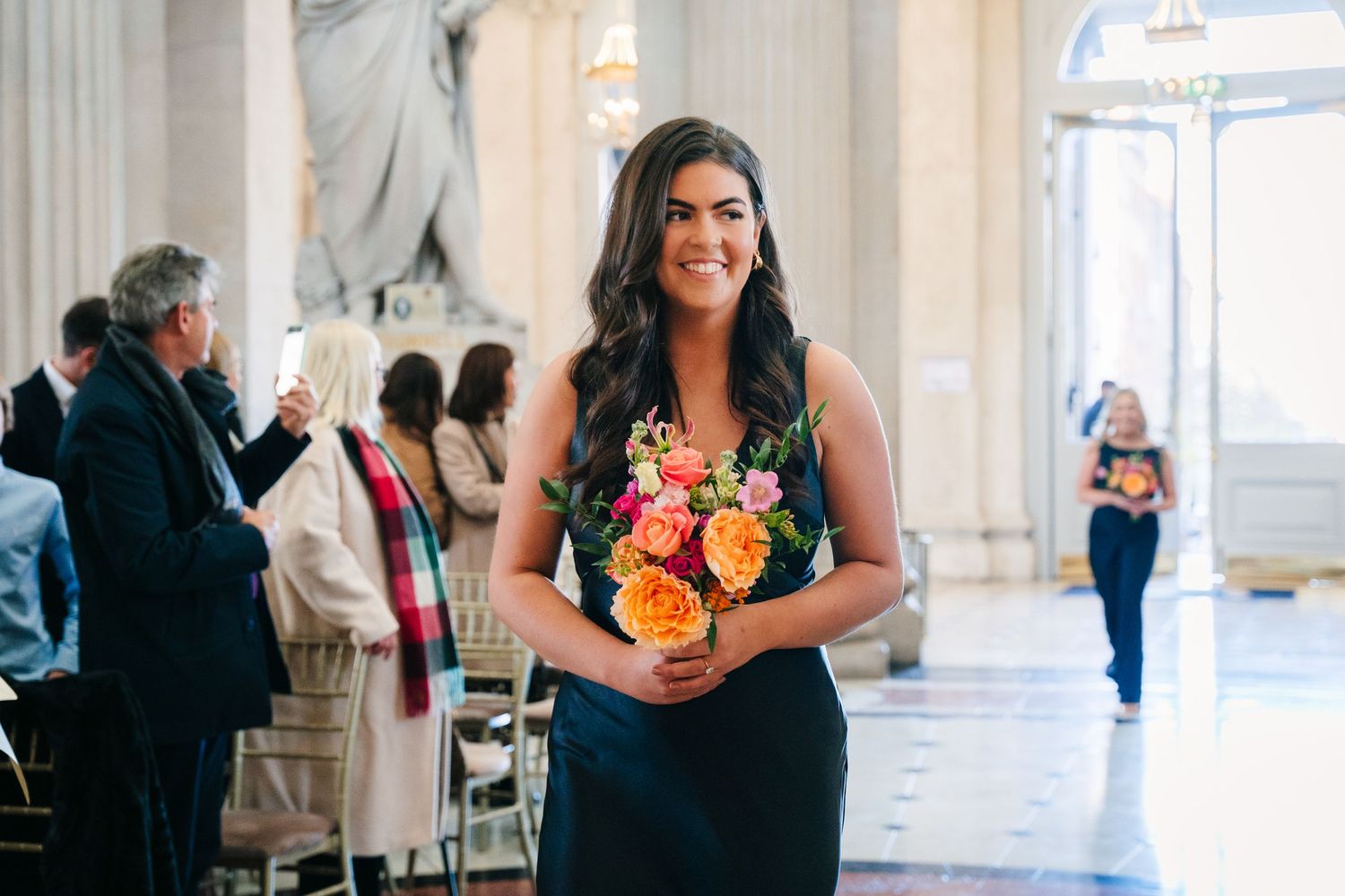 Elegant wedding reception in grand hall with classical white columns and floral arrangements. Wedding photographer dublin
