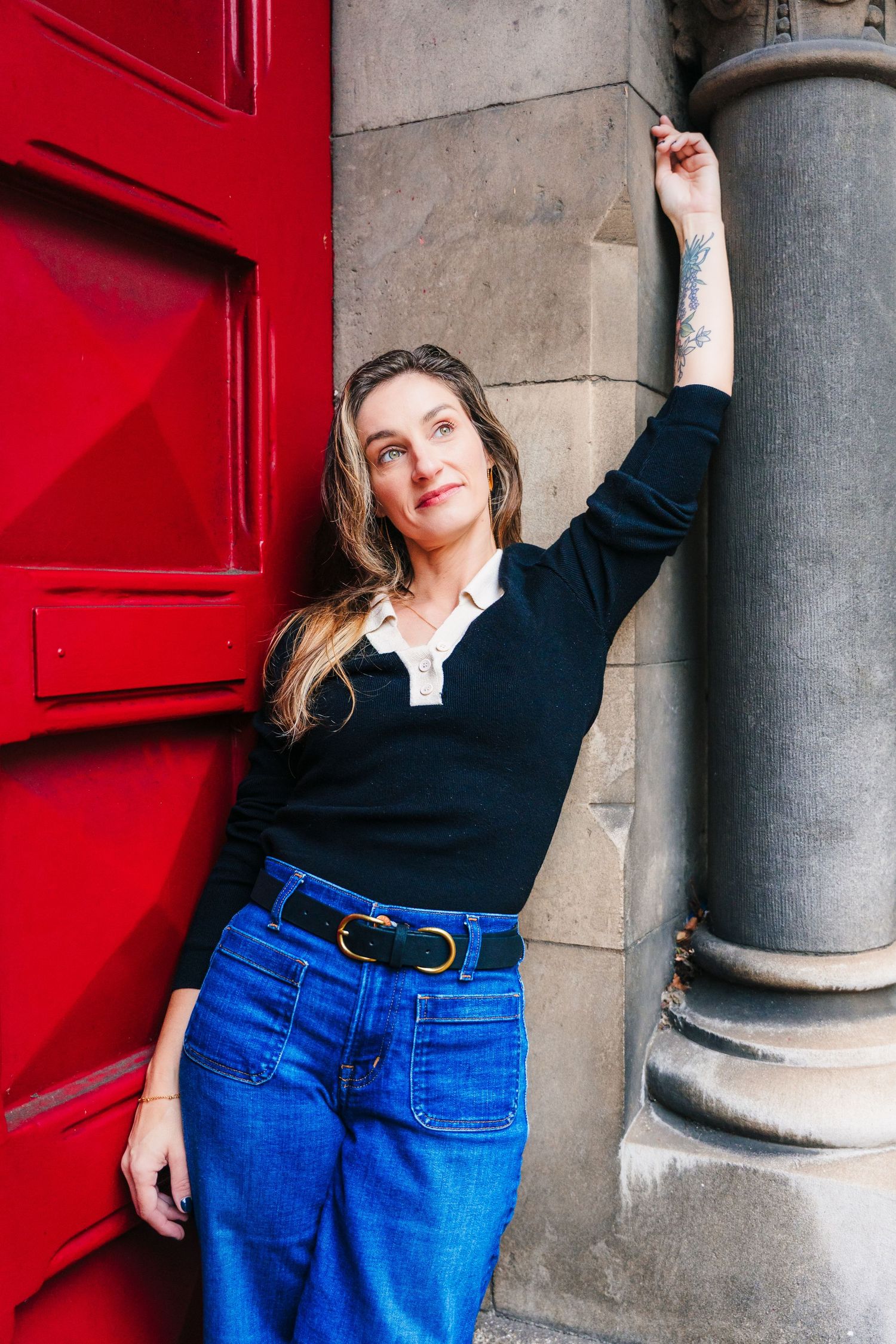 Urban fashion portrait against a bright red door and stone column. professional headshots dublin photographer