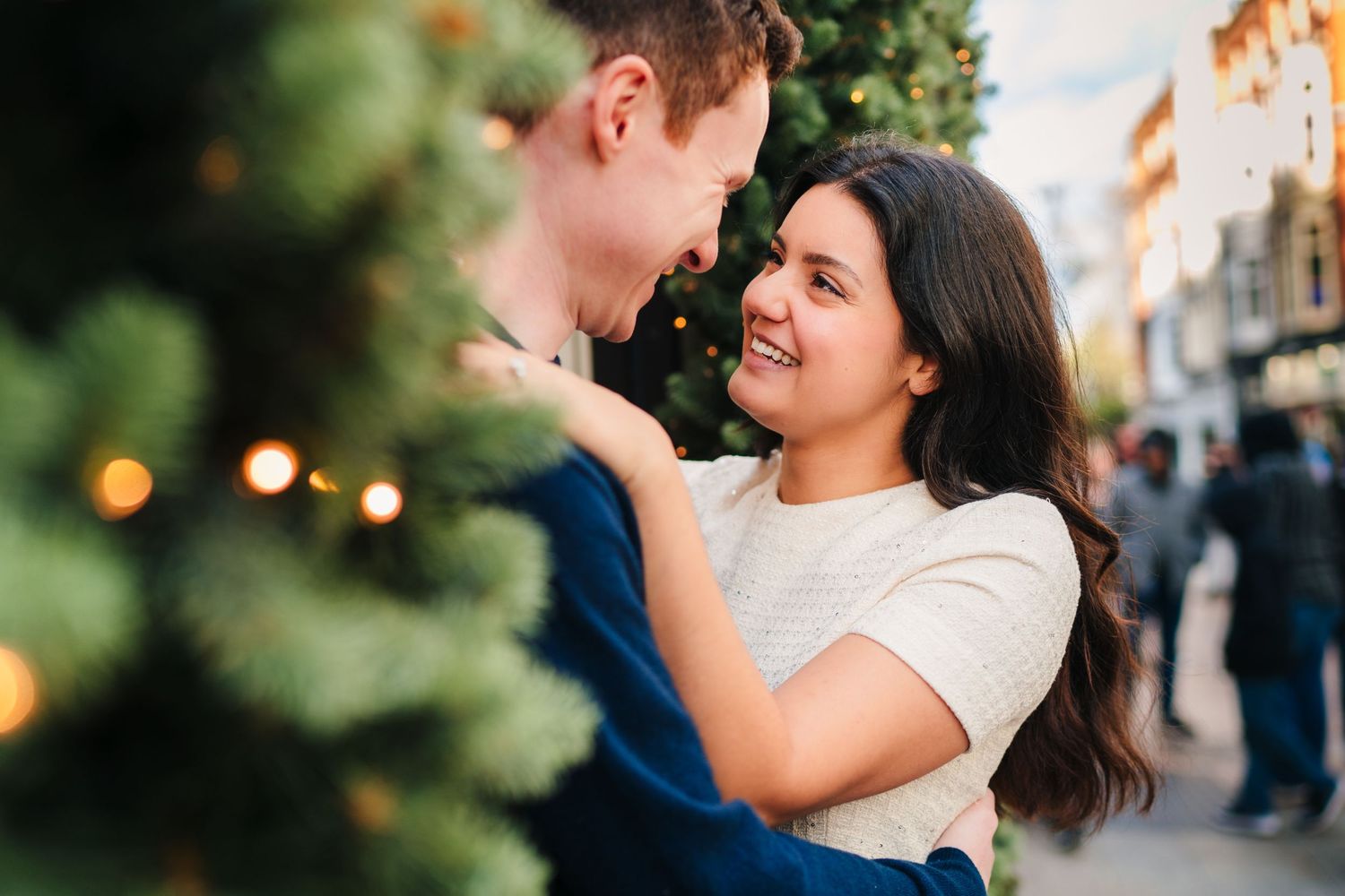 A couple shares a romantic moment together outdoors with soft lighting and greenery in the background. Surprise proposal dublin photography