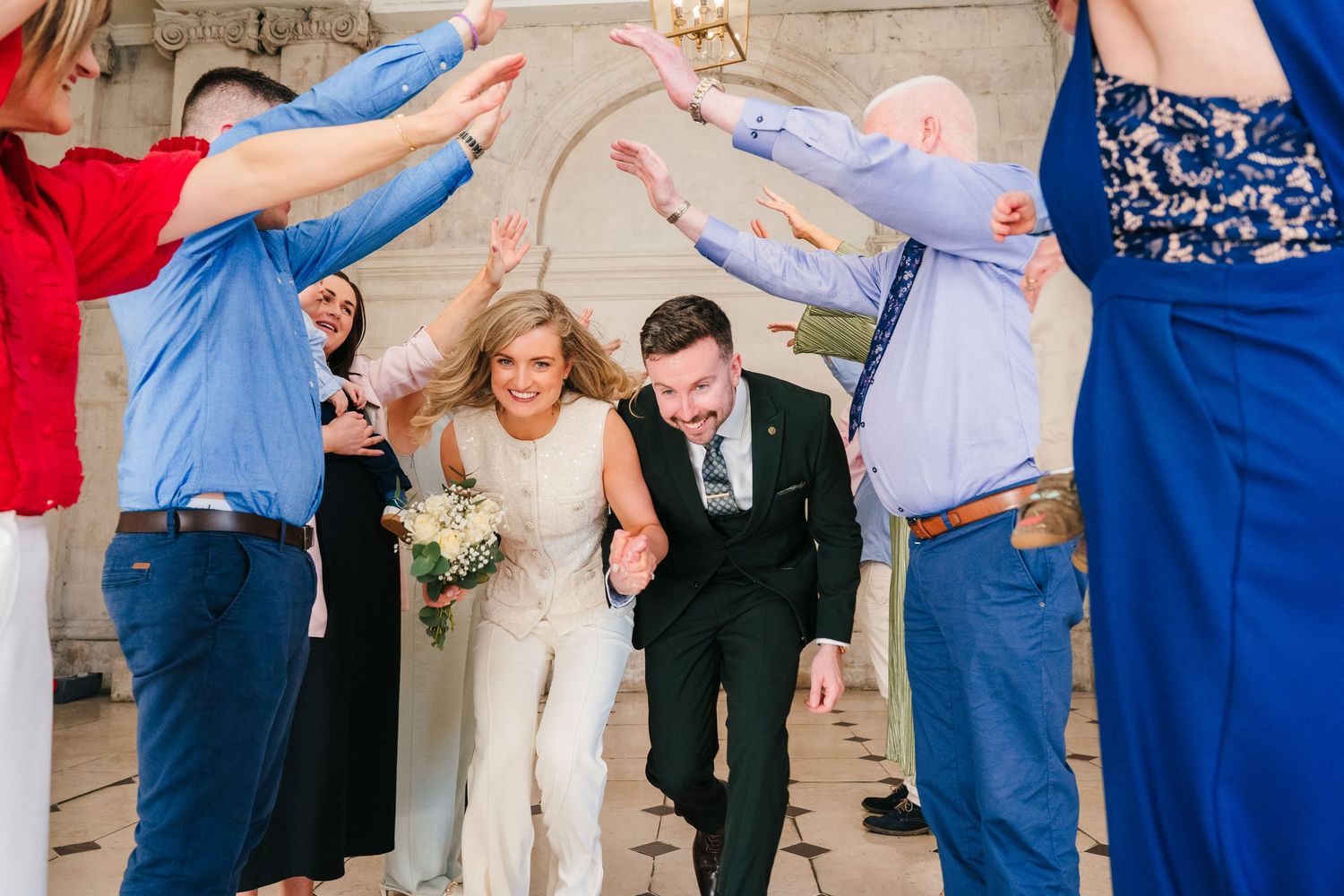 Wedding party in blue and white attire poses together for group photo. City Hall Dublin wedding photogrAPher