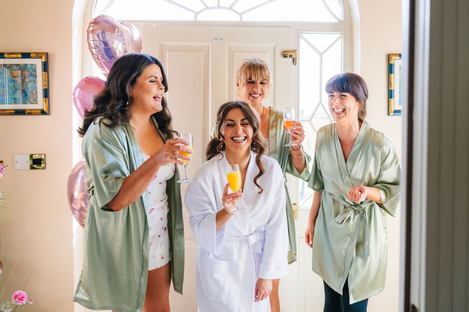 Castle Leslie Wedding Photographer Dublin Wedding party members in pastel green and white outfits laughing and celebrating together.