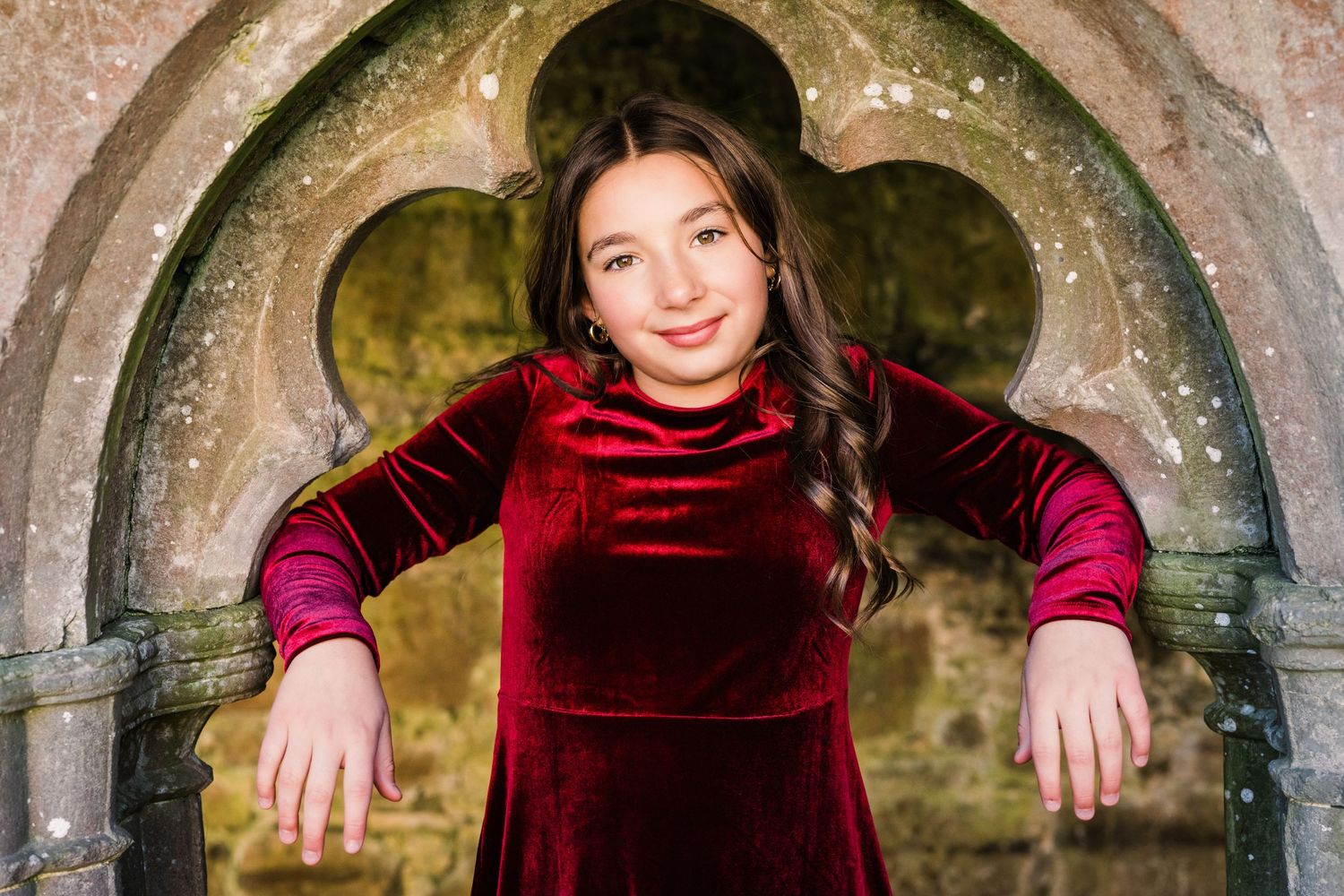 Row of stone arches in historic cloisters with gothic architectural details. Family PHOTOGRAPHER Dublin