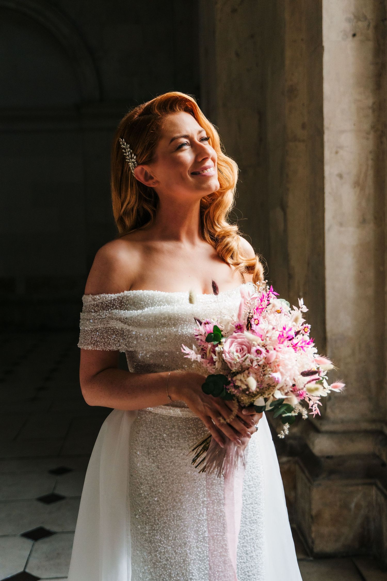 Close-up shots of bride holding pink and white floral bouquet against stone column backdrop.  city hall dublin wedding photos