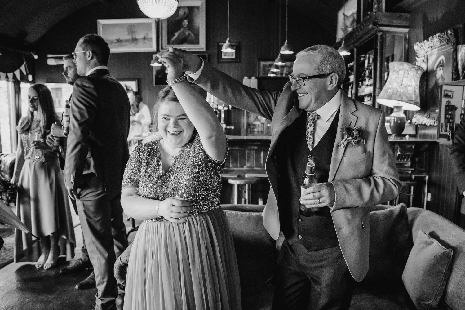 A series of black and white wedding photos showing intimate moments between couples and guests at a reception venue. Wedding PHOTOGRAPHER Du
